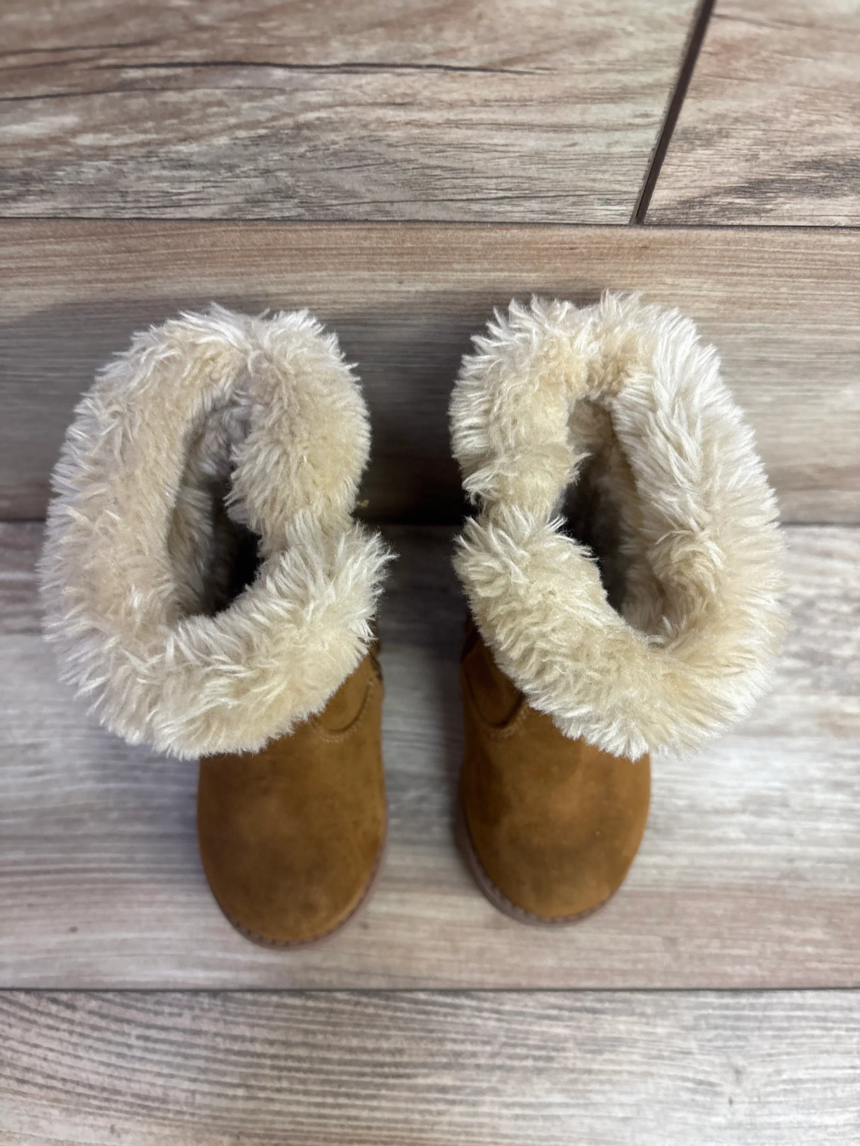 Top-down view of Cat & Jack Honor faux-suede toddler boots showcasing folded cream faux-fur cuff and brown suede upper on wooden floor