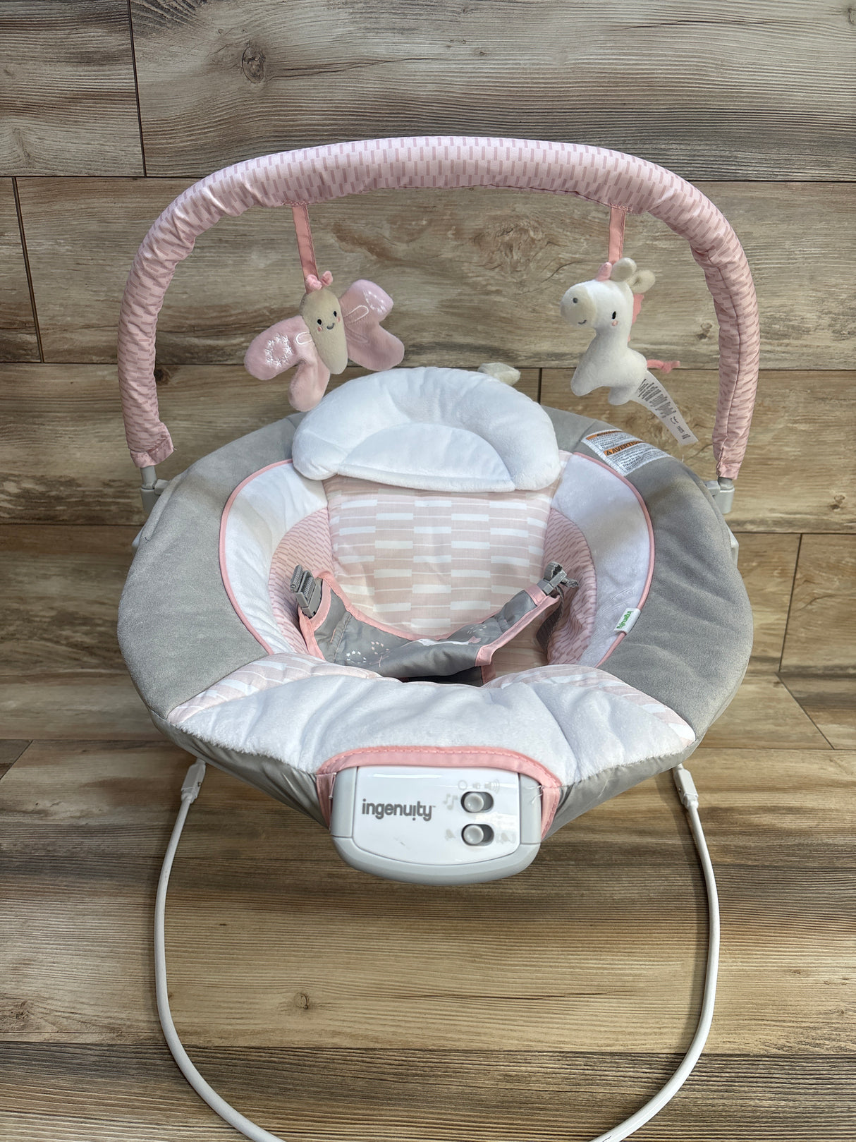 Pink and gray Ingenuity baby swing with plush toys, ideal for infant comfort and play.