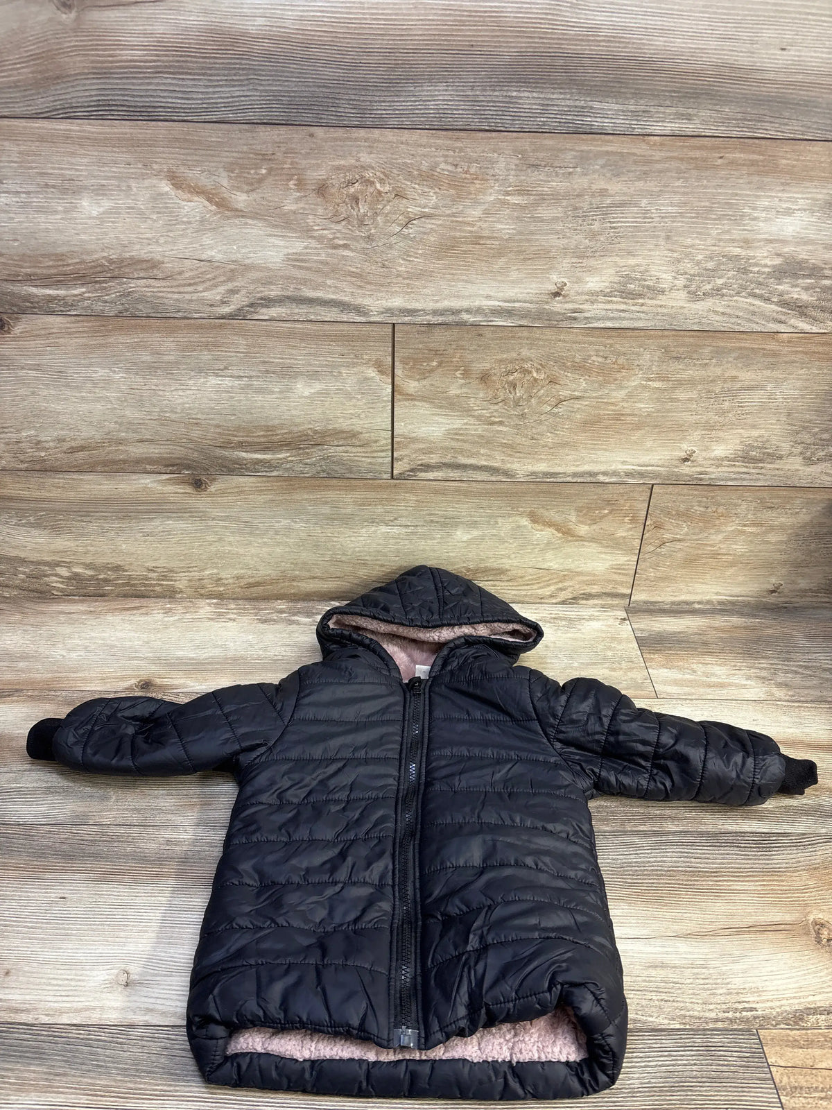 Shein black fur-lined puffer jacket for toddlers in size 4T on a wood background