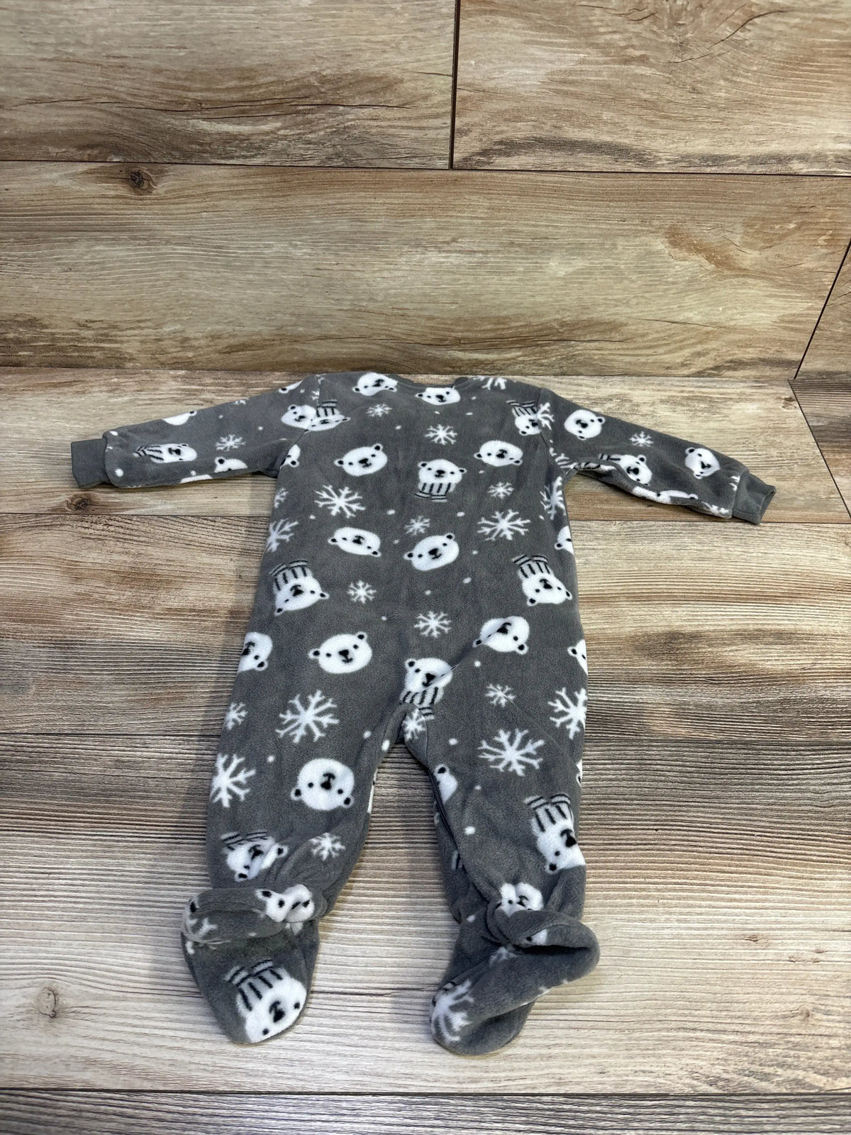 Back view flat-lay of grey fleece footed baby sleeper size 3M with white bear and snowflake print on wood