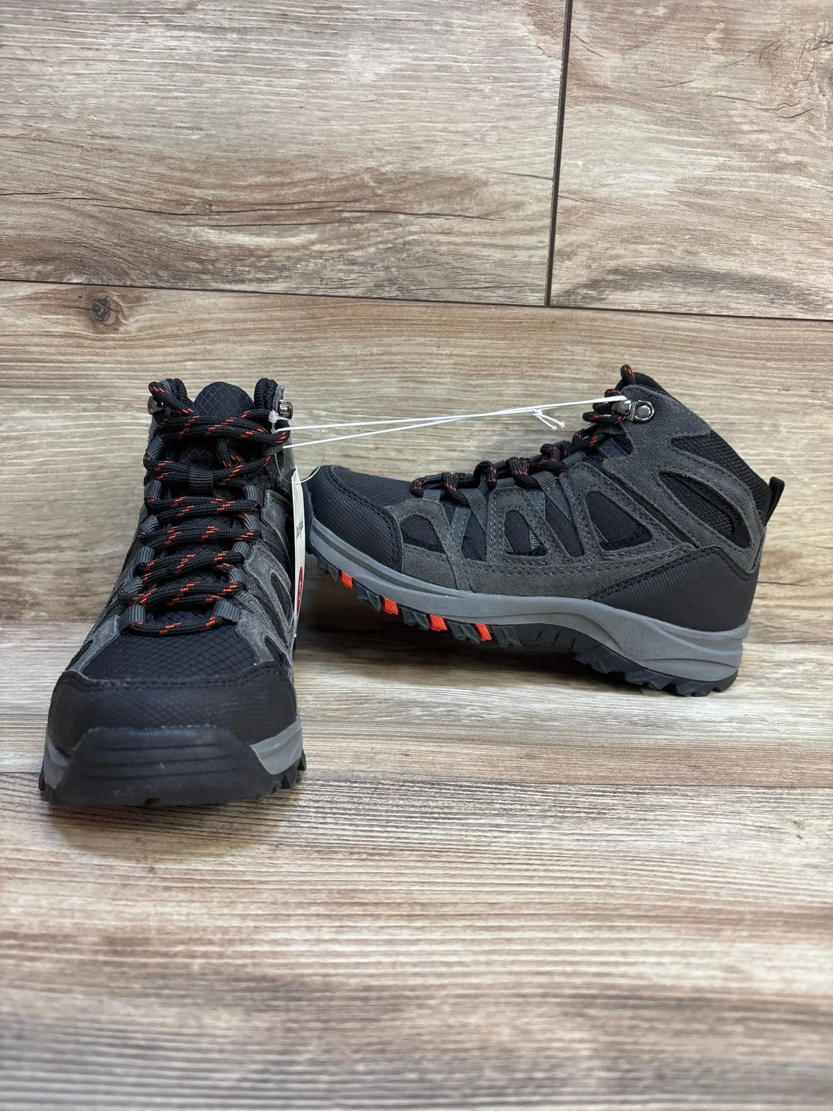 Front and side view of Cat and Jack Patsy kids black and gray hiking boots showing red-accent laces and rugged lug soles on wood floor
