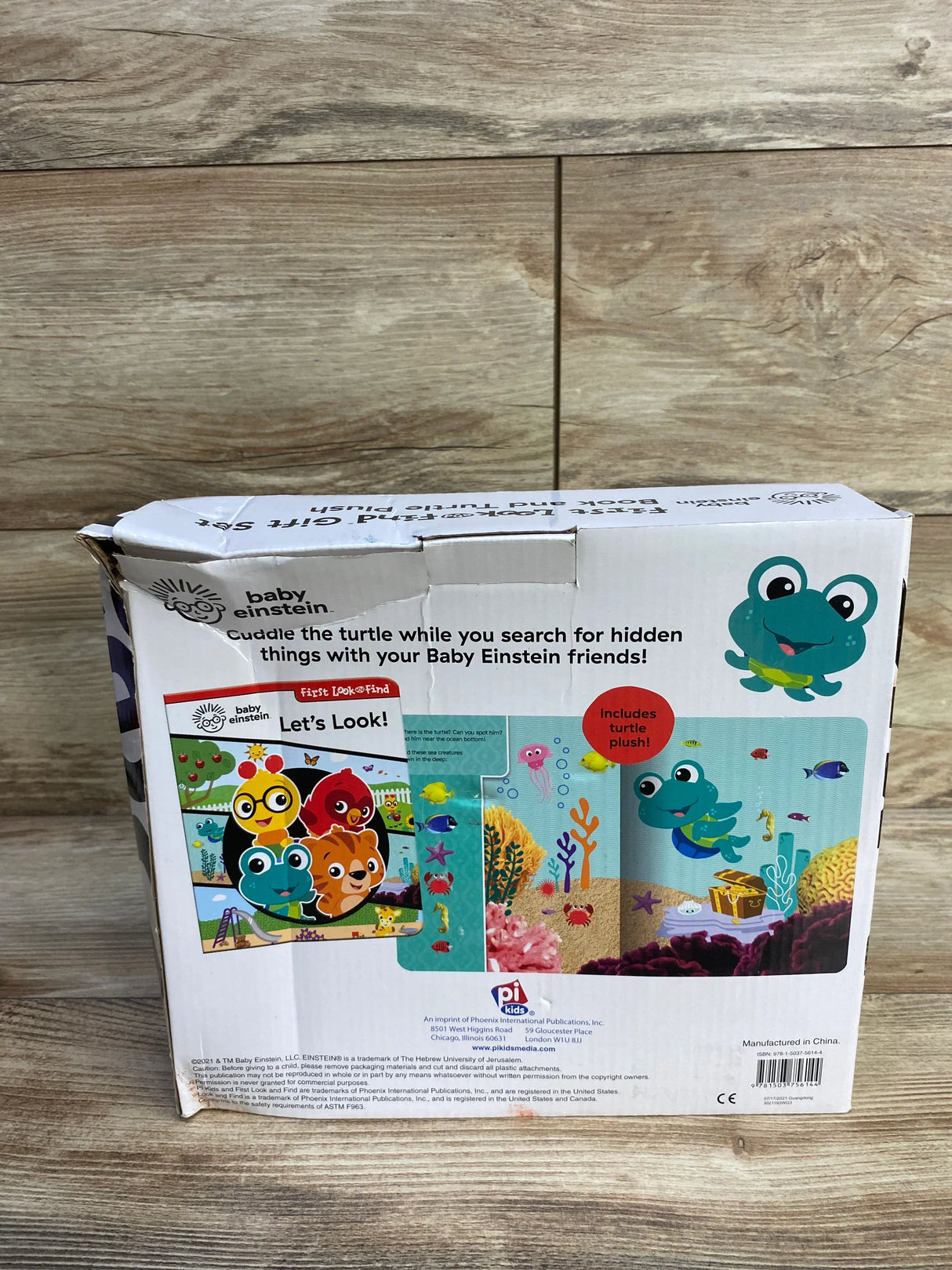 Front view of Baby Einstein First Look & Find gift box with colorful underwater characters and Includes turtle plush label