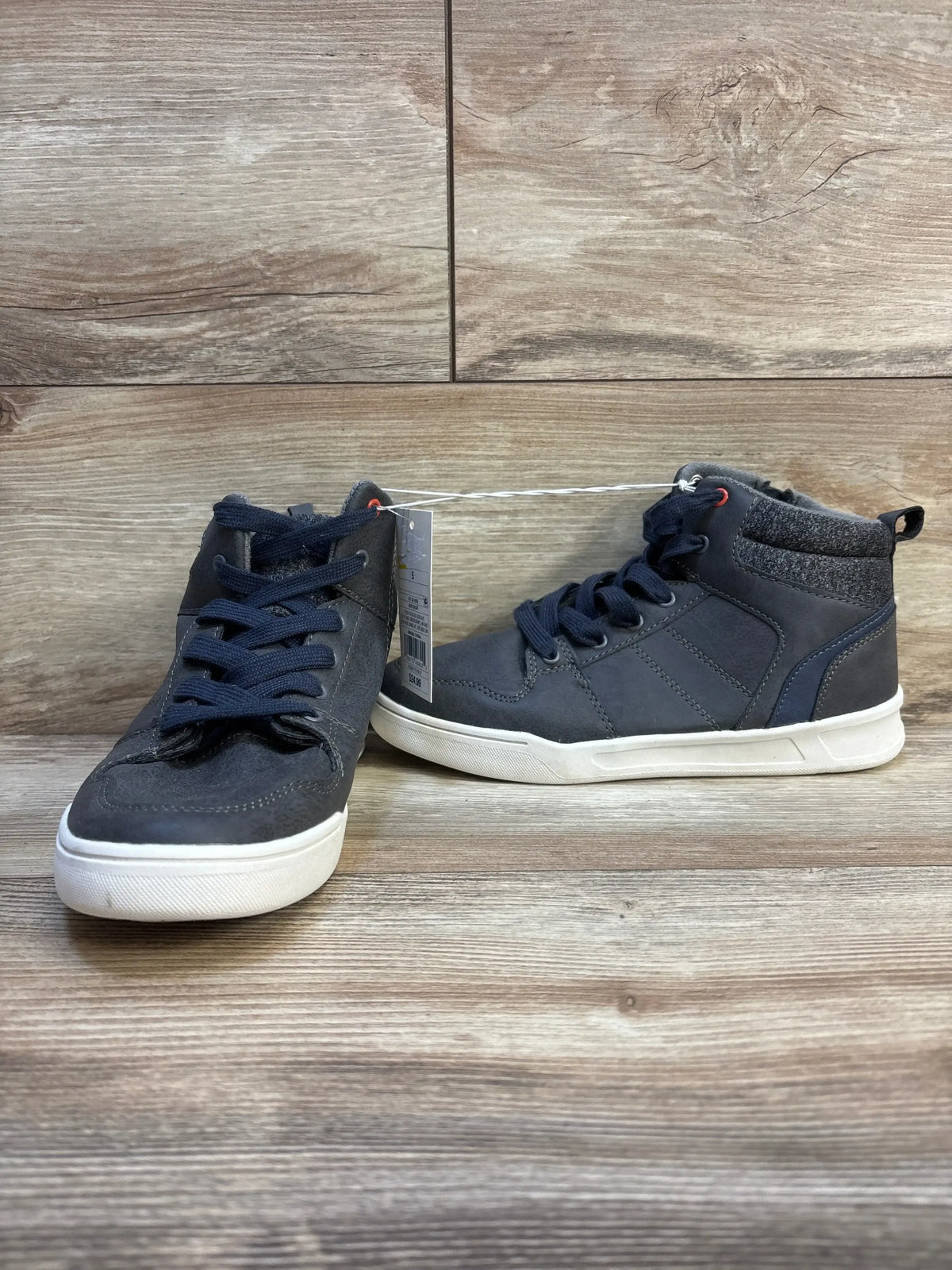 Front and side view of Art Class Geoff high-top sneakers showcasing grey uppers, laces, and white soles on a wood background