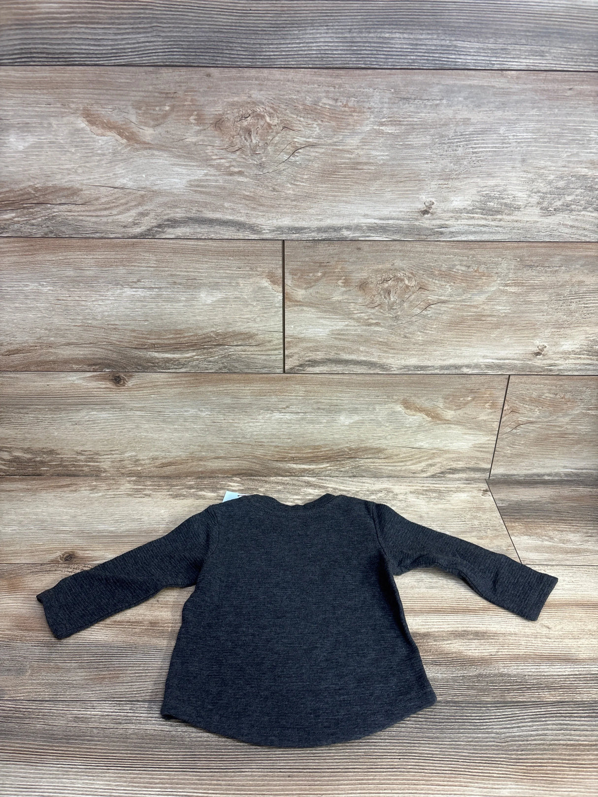 Back view of NEW Cat and Jack Ribbed Pocket Shirt in grey sz 12m showcasing long sleeves and curved hem on wood plank floor