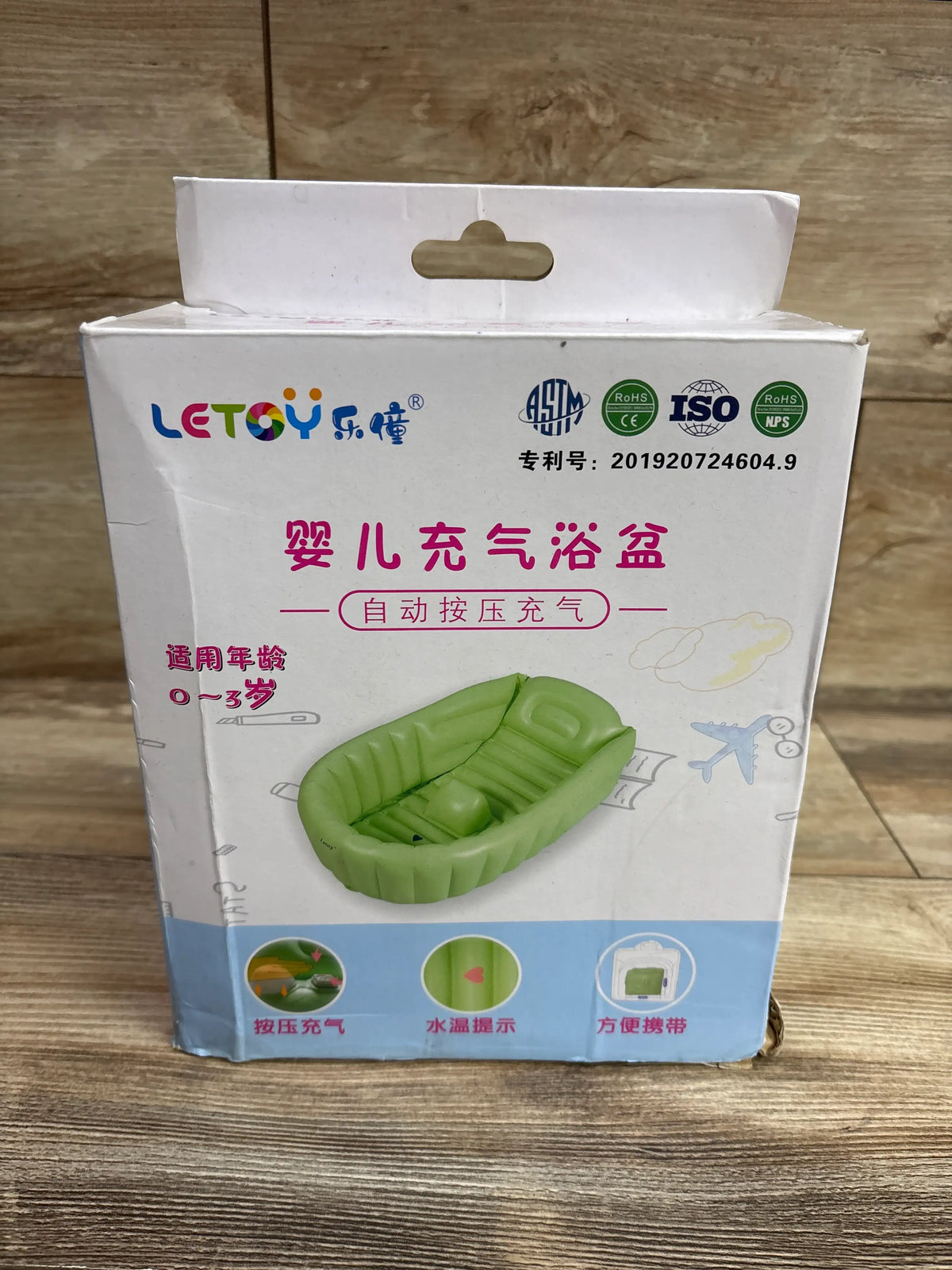 Front view of a green Letoy inflatable bathtub displayed on its product box