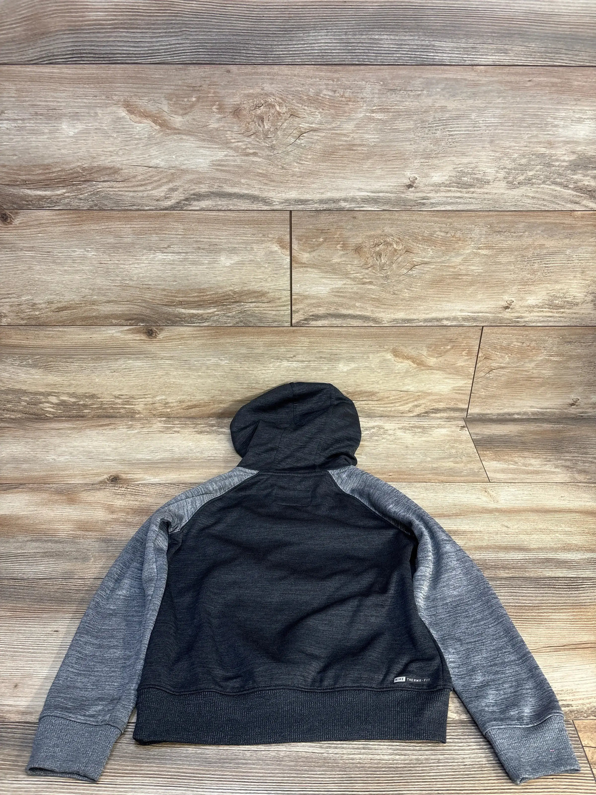 Back view of Hurley boys 5T grey and black hoodie showing hood and heather grey raglan sleeves on wood floor