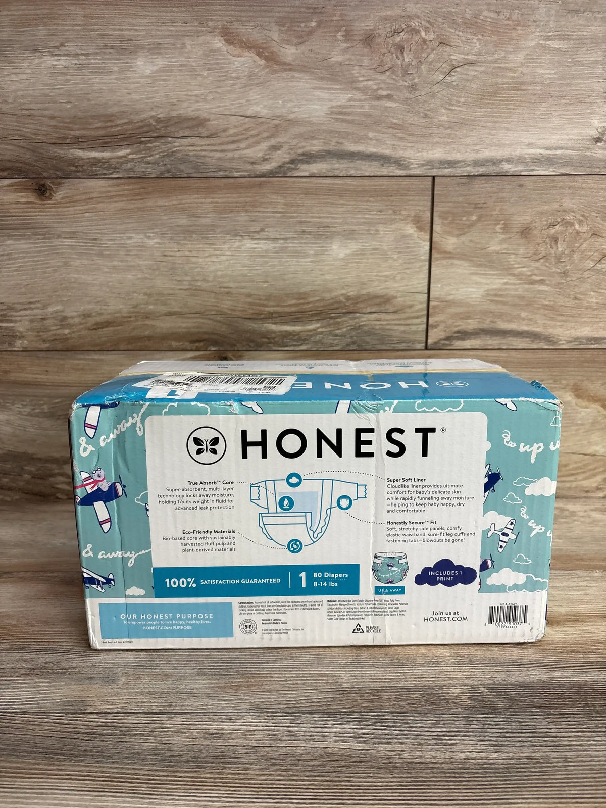 Box of Honest brand eco-friendly disposable baby diapers, size 1, 80 count, with airplane print