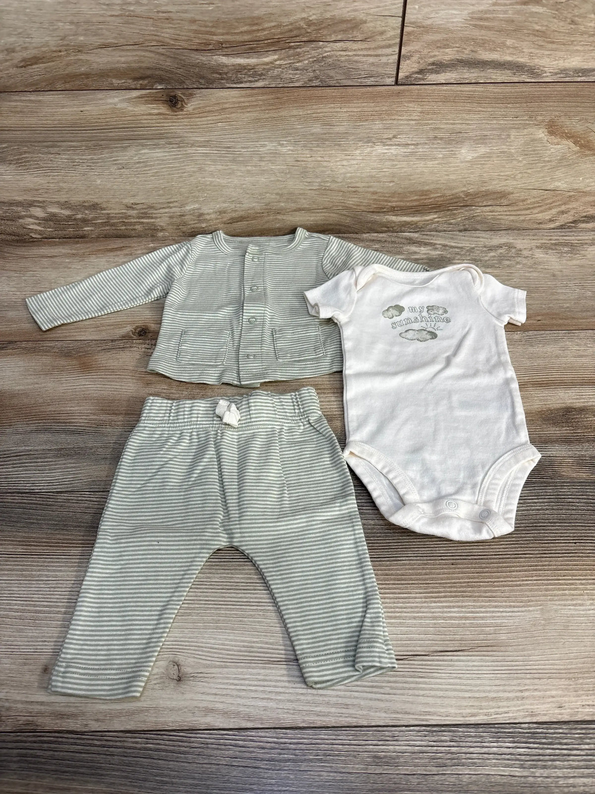 Front view of Carter’s 3-piece bodysuit set showing white my sunshine bodysuit with striped cardigan and pants on wood floor