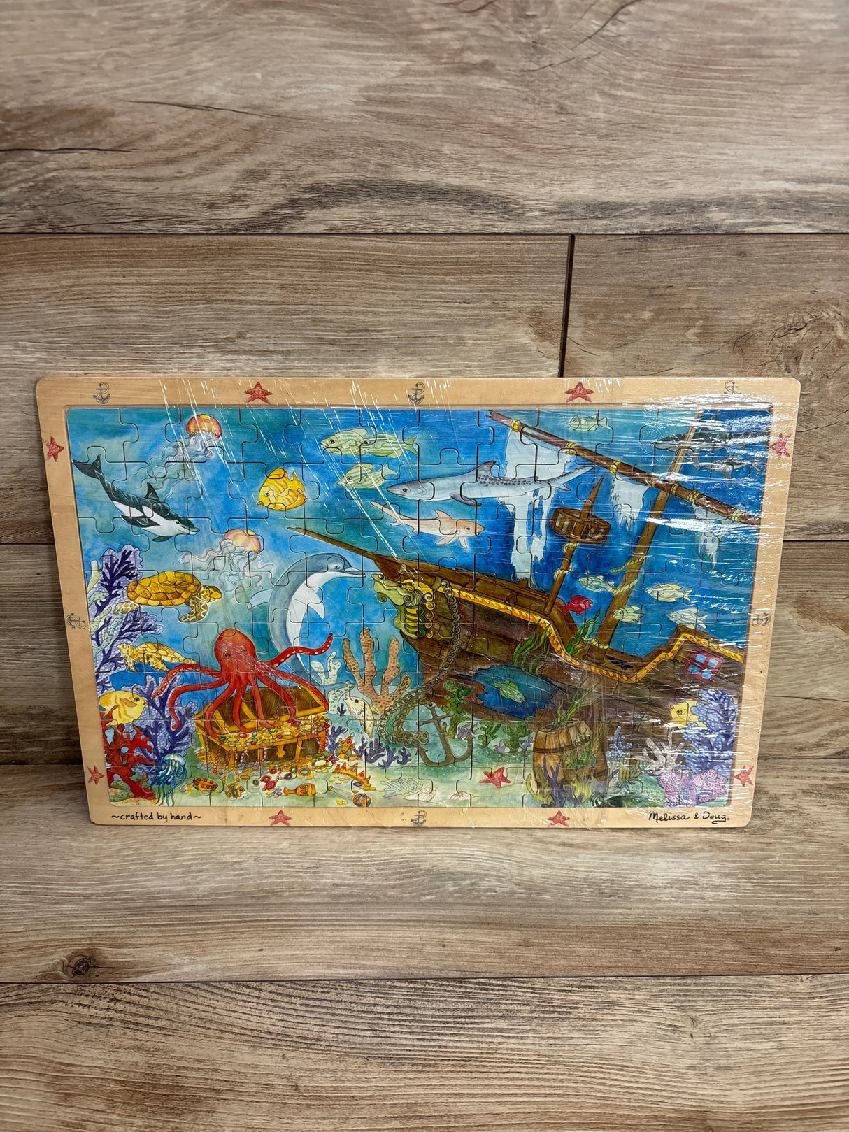 Underwater ocean wooden puzzle featuring sea animals, treasure chest, and sunken pirate ship