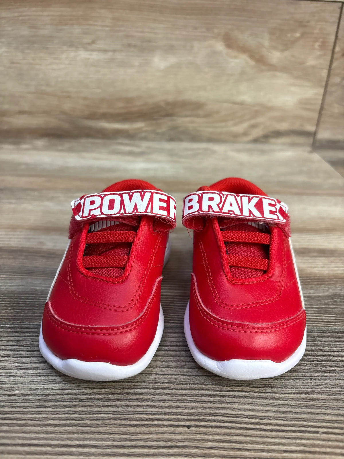 Front view of red Puma x Scuderia Ferrari Kart Cat III sneakers with POWER BRAKE hook and loop straps