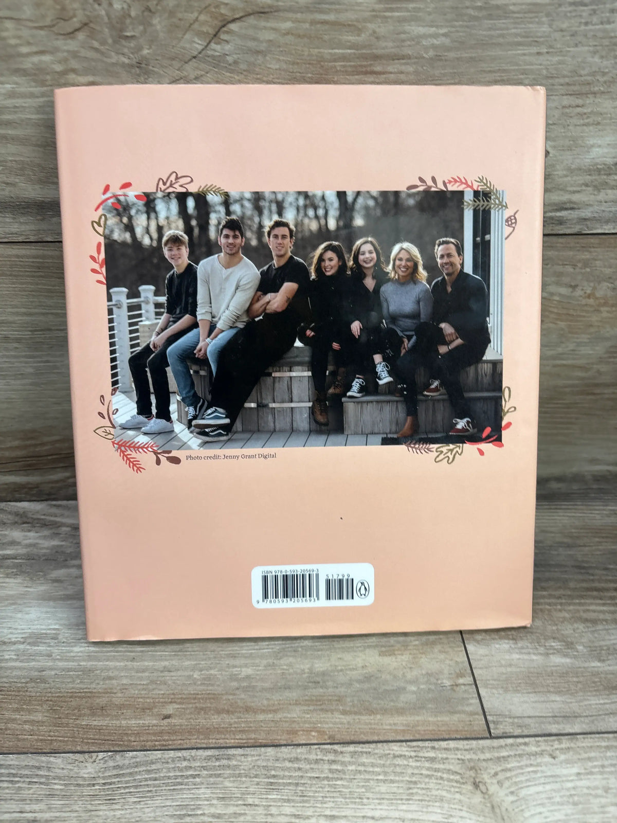 Back cover of Better Together hardcover book showing eight people seated outdoors on a peach cover with floral border