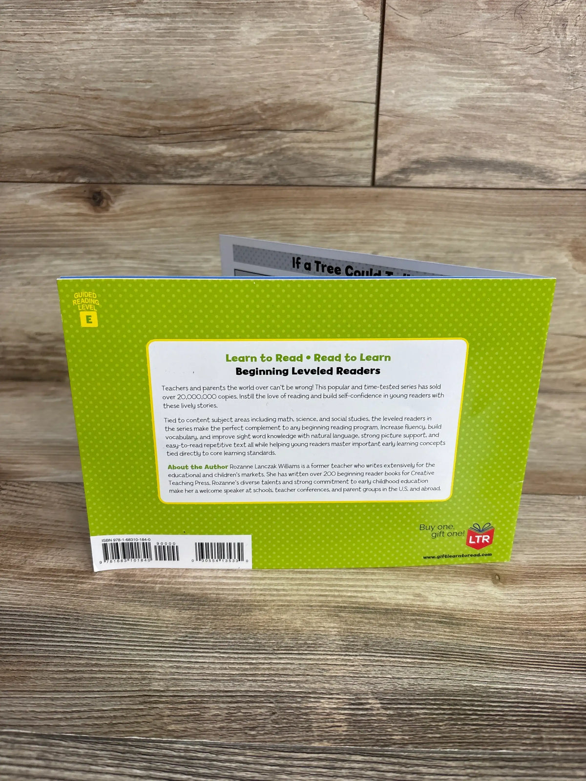 Back of If a Tree Could Talk paperback showing green polka-dot back cover with Beginning Leveled Readers headline, author blurb, guided reading level E badge and barcode on wood surface