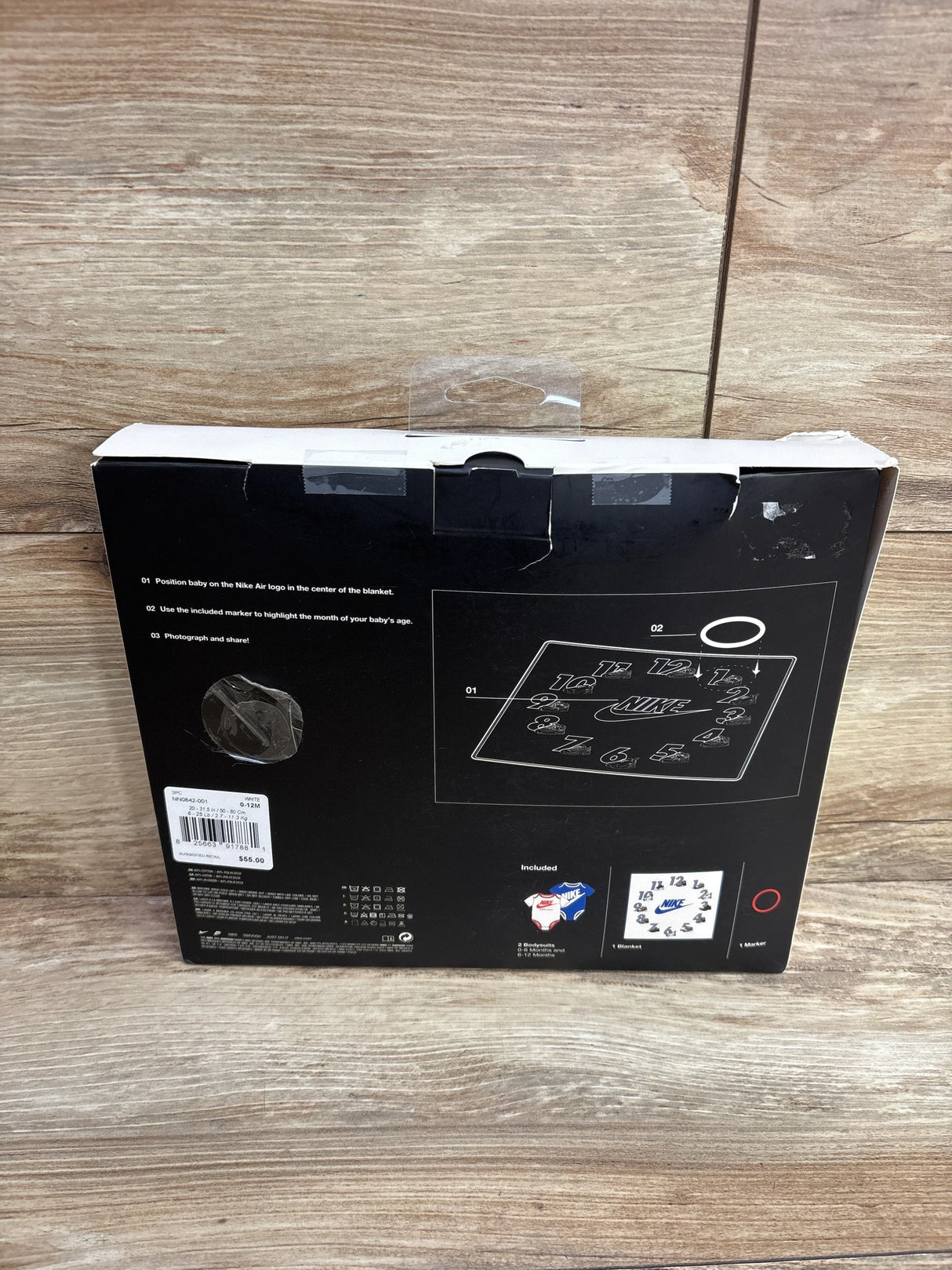 Nike baby milestone blanket set packaging with instructions, includes 2 bodysuits, marker, and blanket