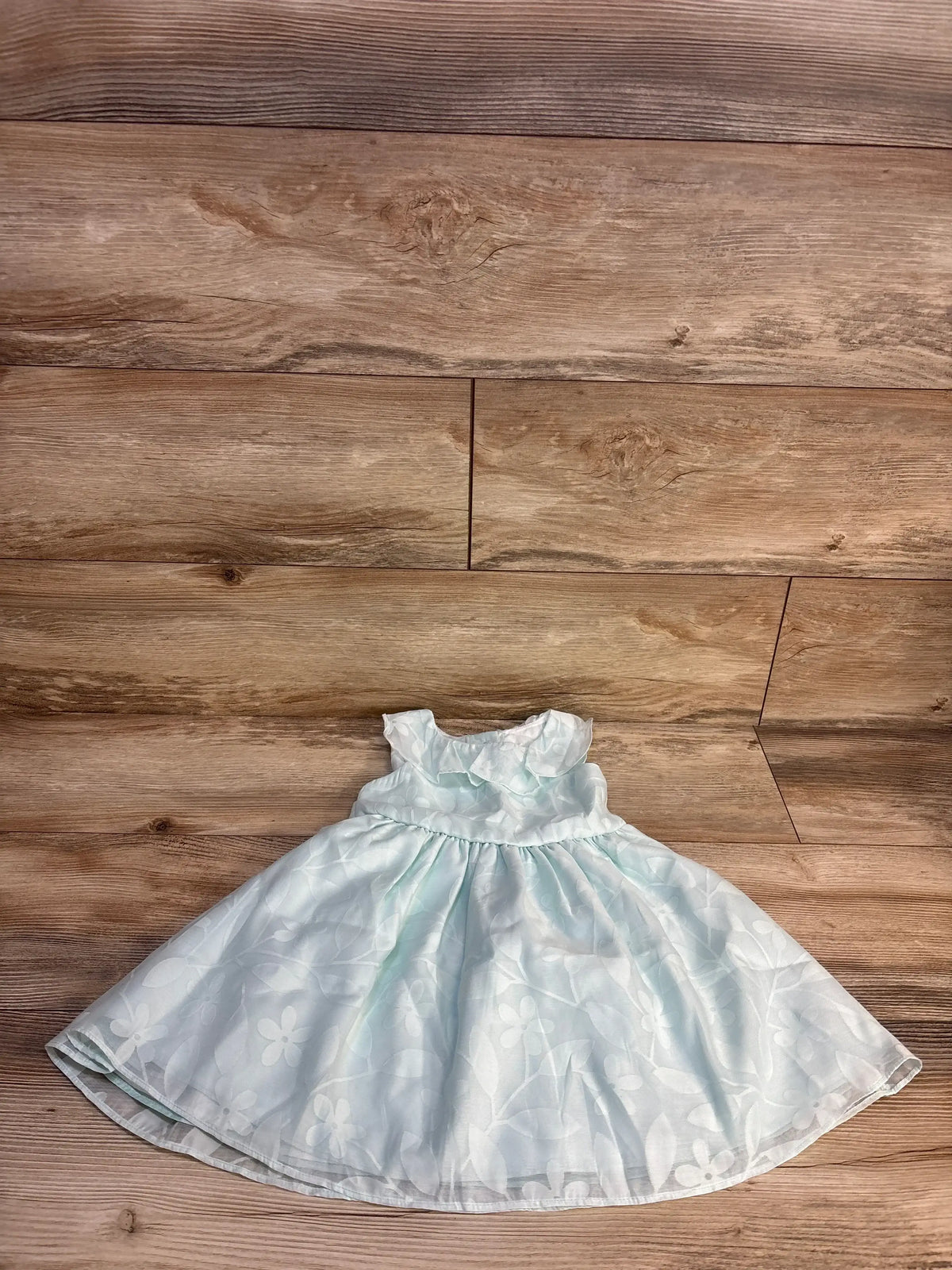 Light blue floral girls dress with ruffle collar on wood background, children's resale clothing
