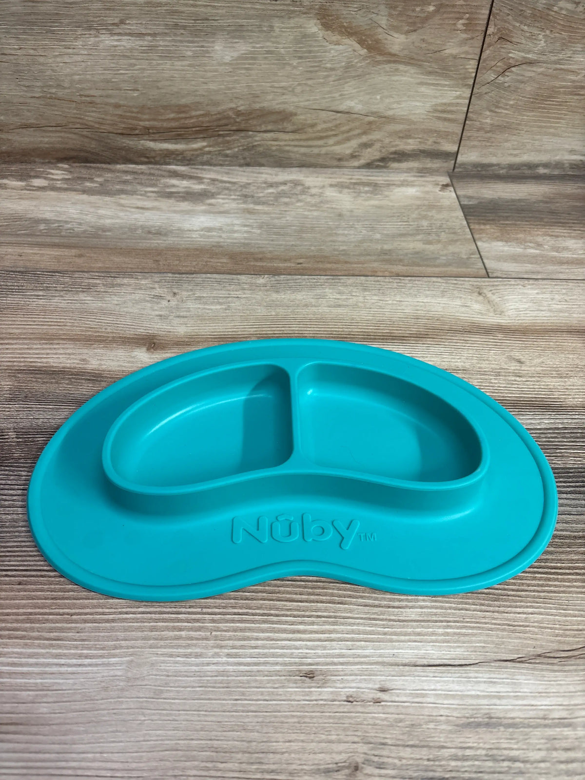 Aqua blue Me n Mommy To Be 2-section silicone baby plate on a wooden surface