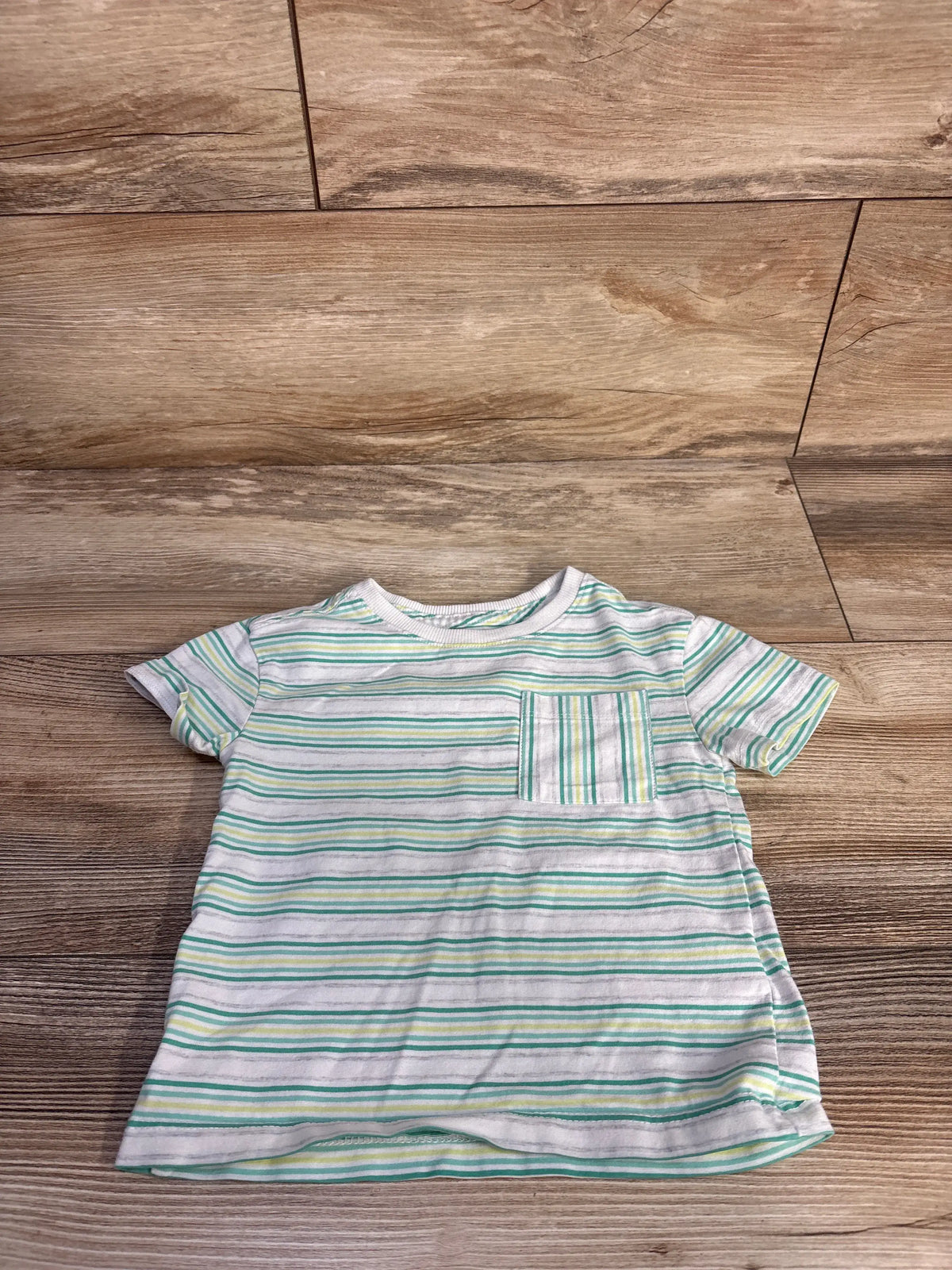 Front view of white Flapdoodles striped shirt showcasing chest pocket and short sleeves on a wood floor