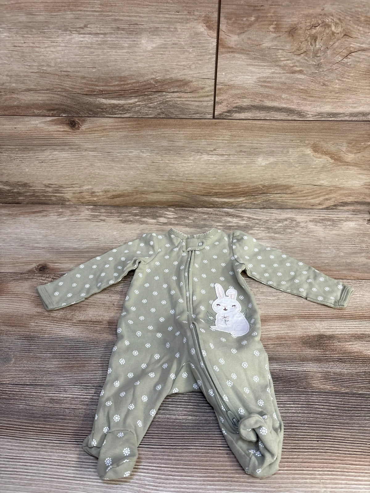 Front view of Carter’s soft green newborn bunny sleeper with white floral pattern, bunny applique, long sleeves, and covered feet