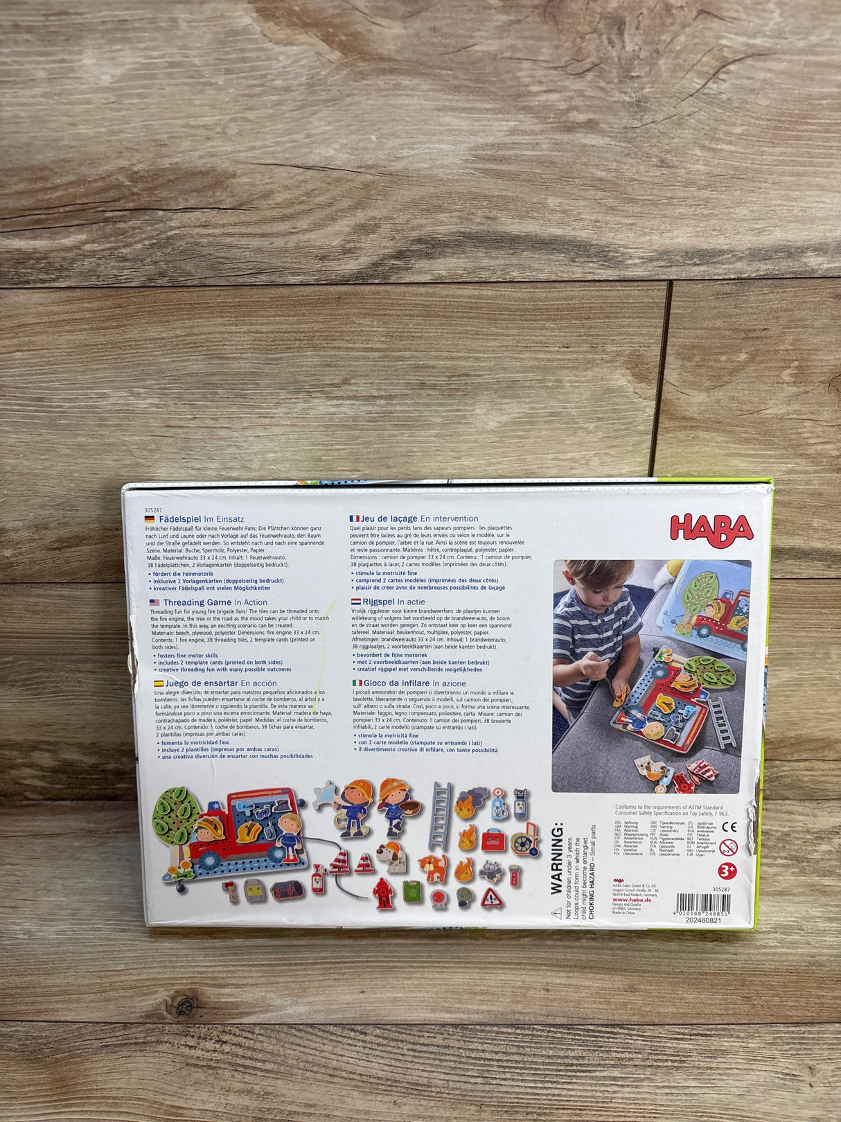 Back of HABA threading game box with colorful wooden pieces and child playing, educational toy