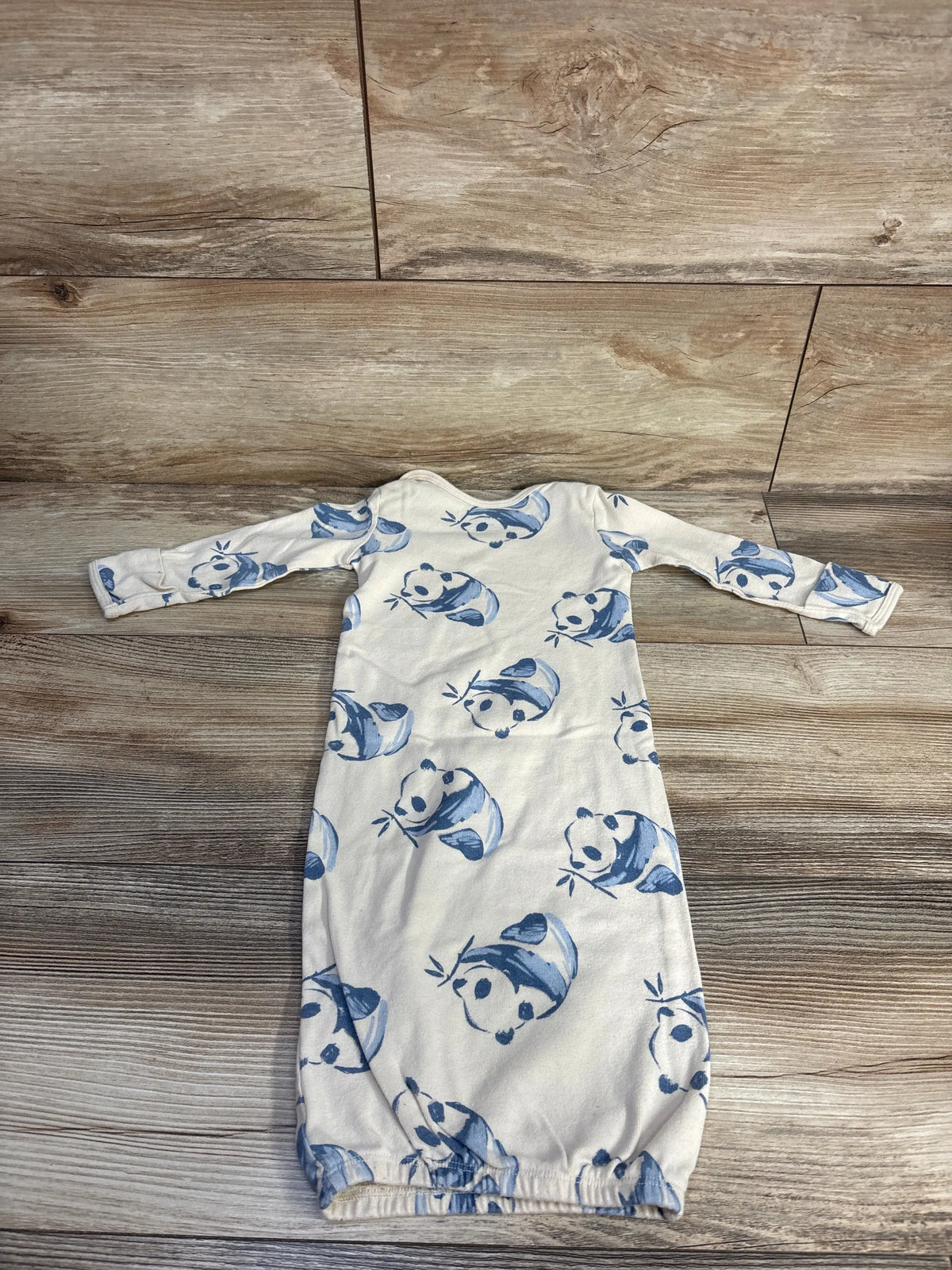 Front view of Carter’s beige panda print sleep gown, size 3 months, showcasing gathered hem on a wood floor