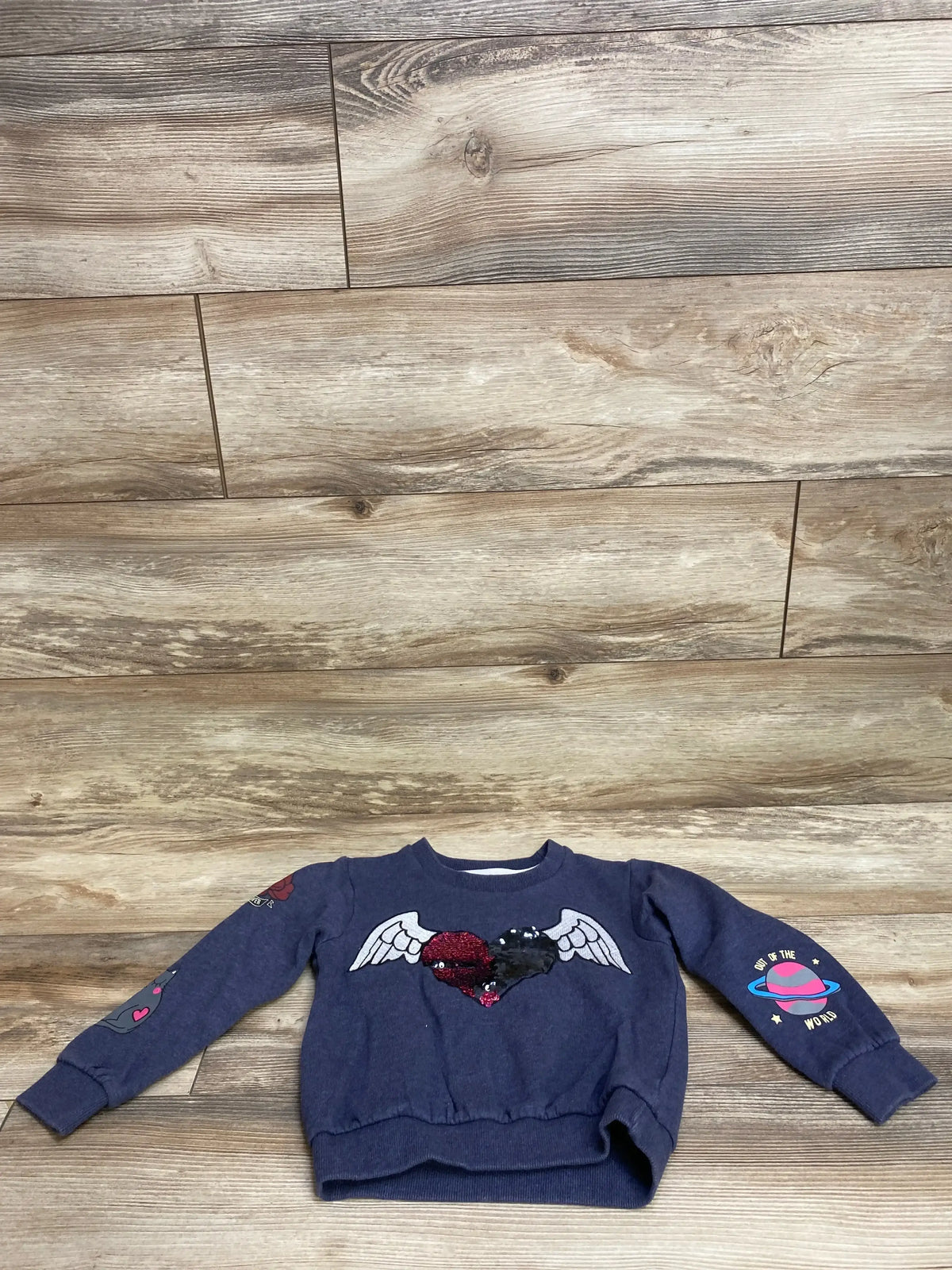 Navy blue children's sweatshirt with sequin heart and wings design, space and heart sleeve prints