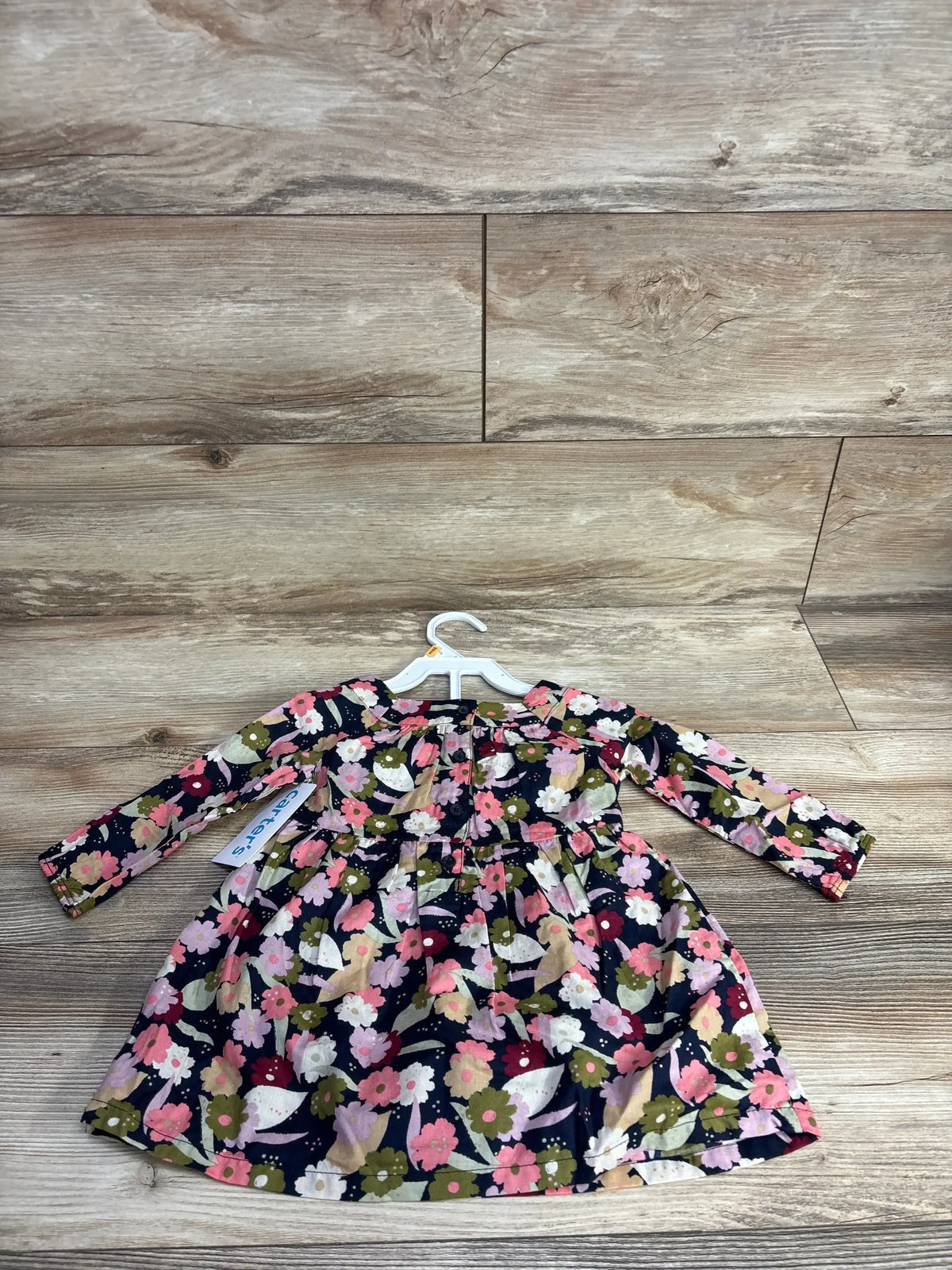 Long sleeve floral toddler dress with pink, white, and green flowers on navy background
