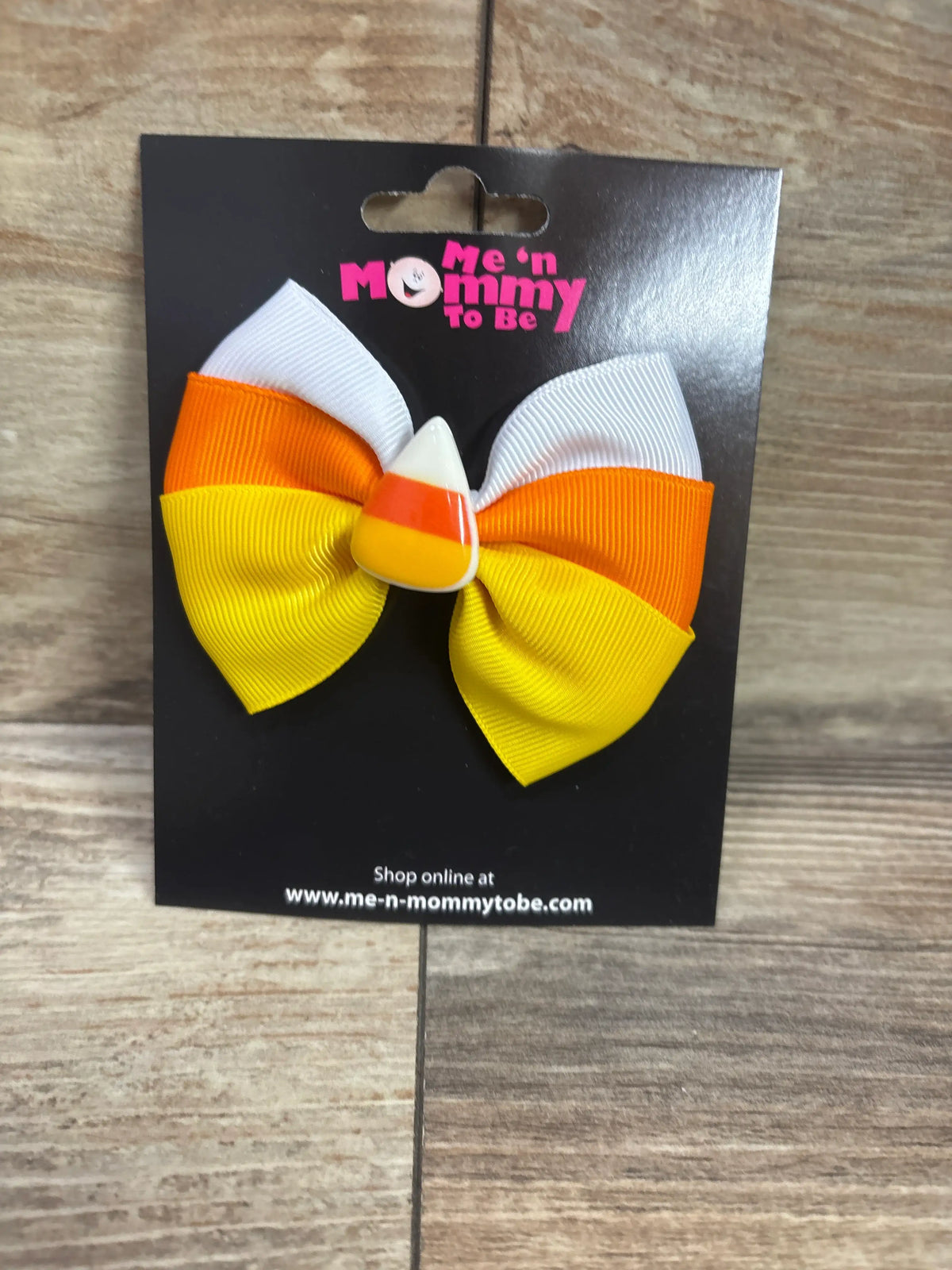 Candy Corn Applique Hair Bow in yellow, orange, and white on a black display card.