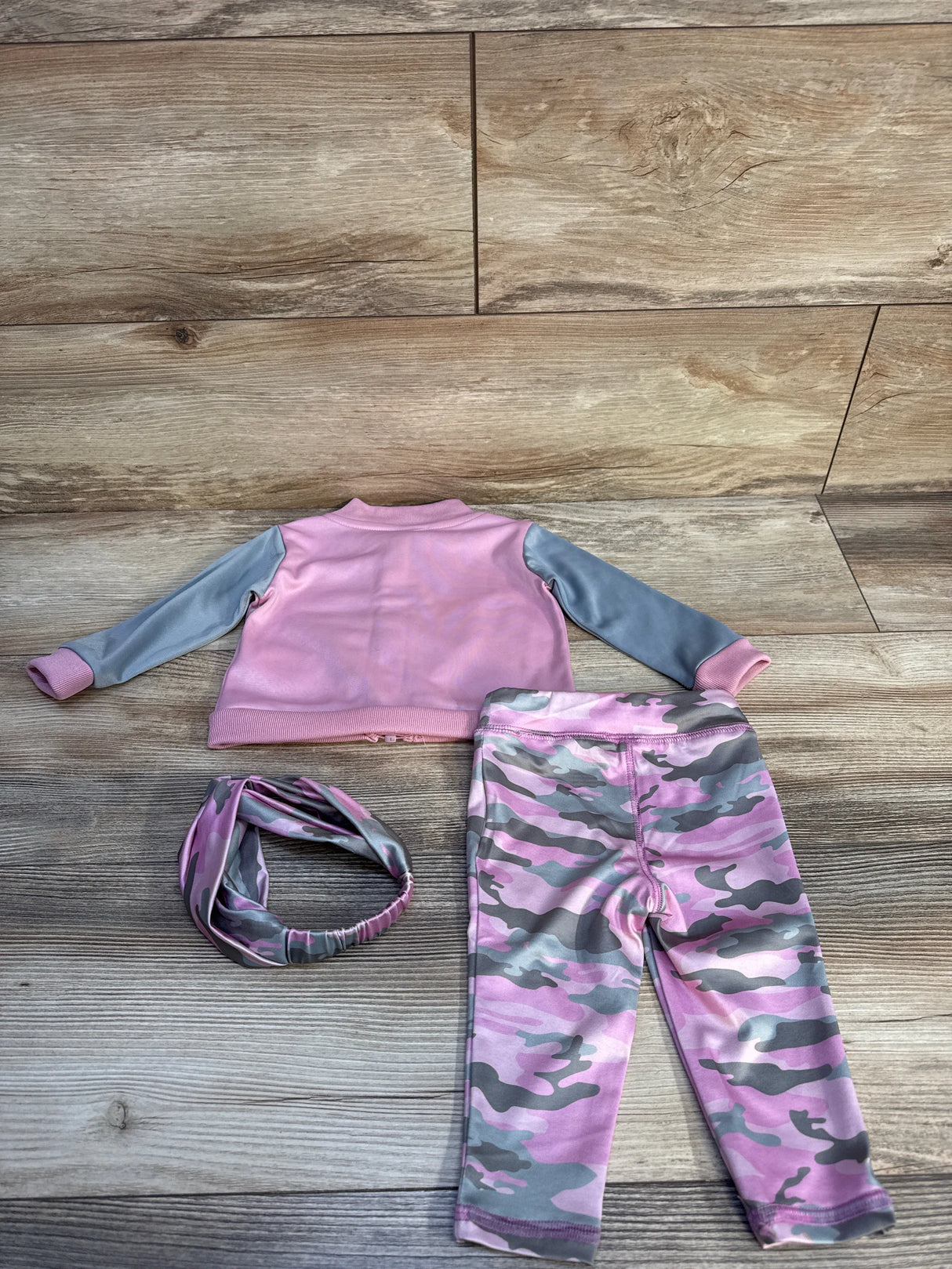 Pink and gray toddler outfit with camouflage leggings, long-sleeve jacket, and matching headband