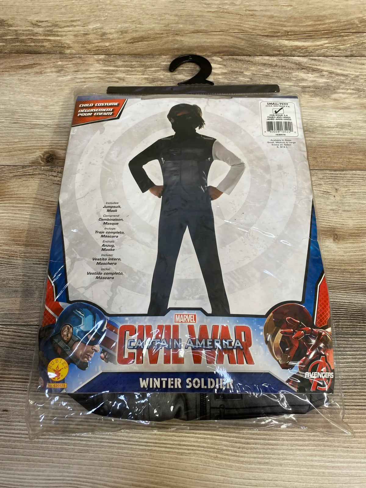 Front view of Marvel Winter Soldier costume package showcasing black jumpsuit and mask on a wooden table