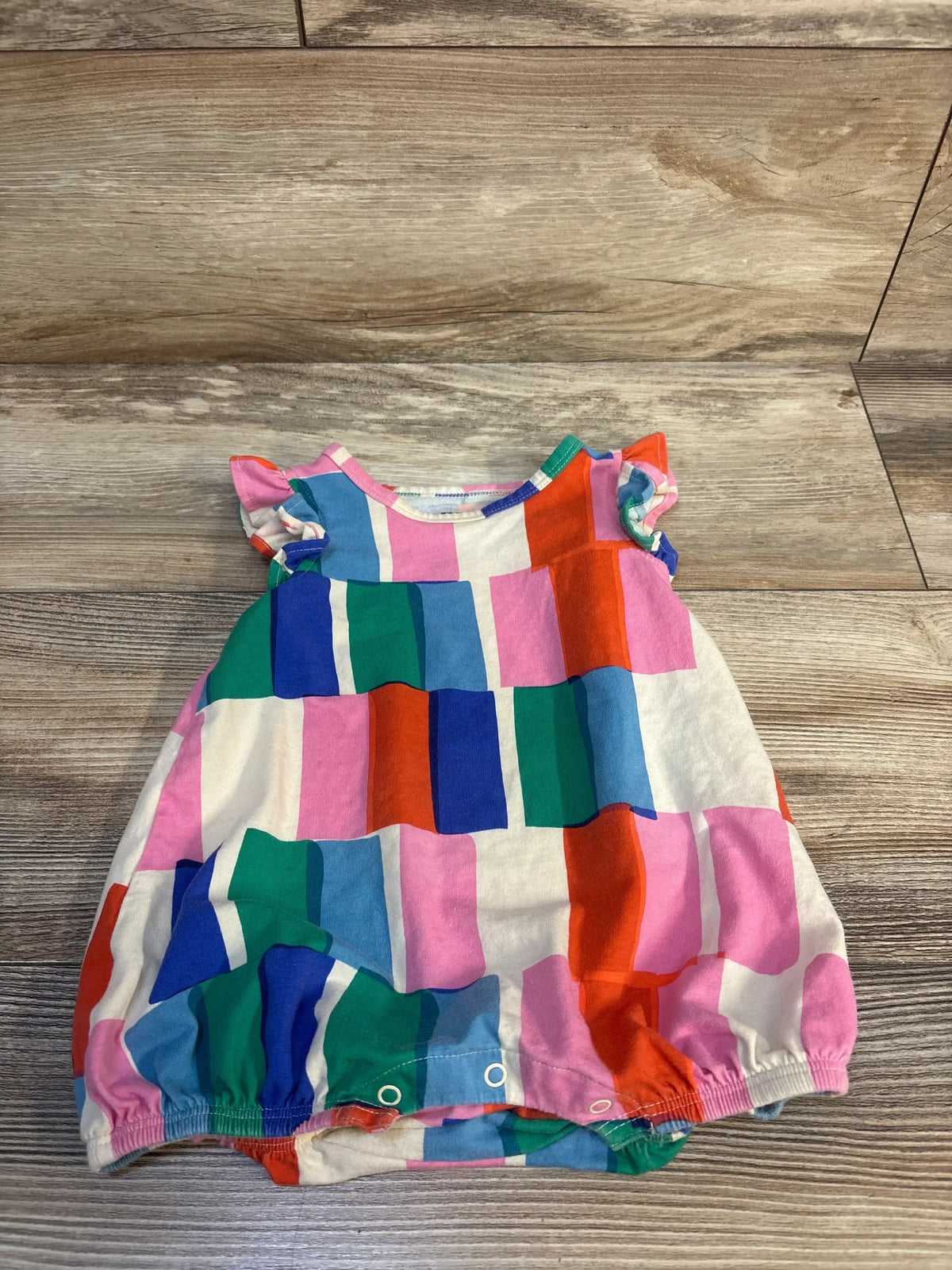 Colorful patchwork baby romper with ruffled sleeves, perfect for kids clothing resale