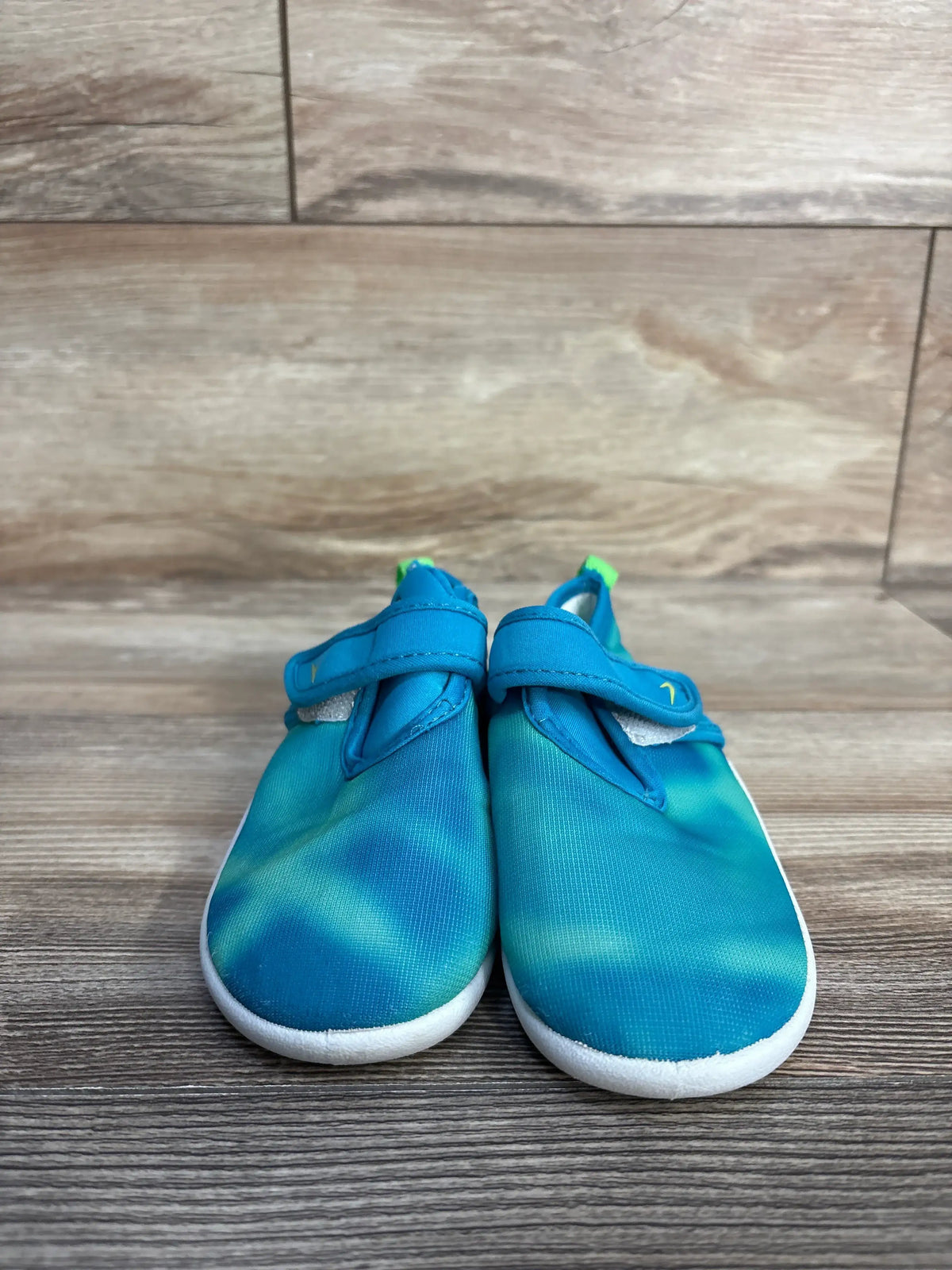 Front view of Speedo Shore Explorer water shoes in seafoam with mesh uppers and closure straps on wood flooring