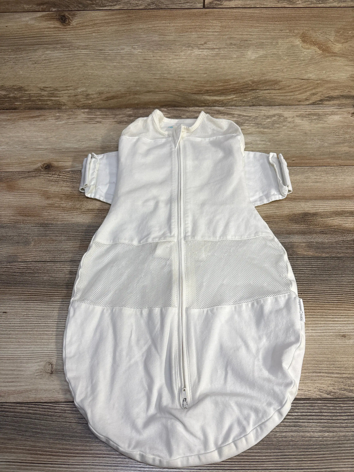 White Me n Mommy To Be Happiest Baby SNOO sleep sack in size medium laid on a wooden surface