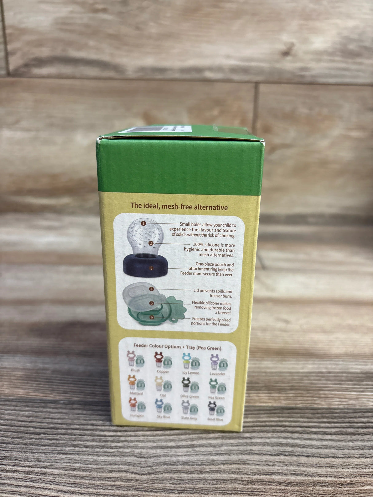 Back of Haakaa Freeze-N-Feed Mini Combo box with headline The ideal, mesh-free alternative and feeder images on wooden table
