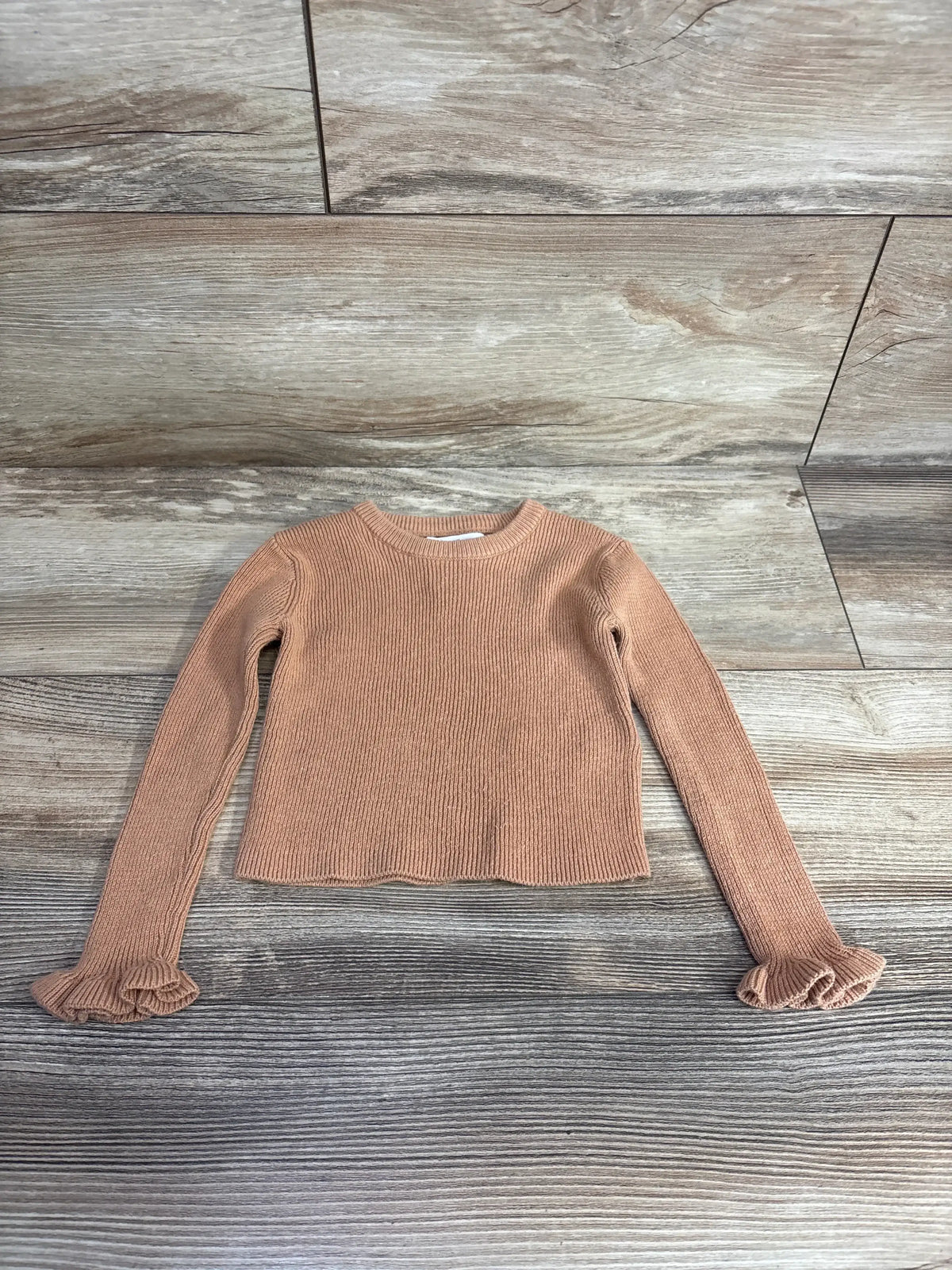 Front view of Tommy Bahama ribbed long-sleeve toddler shirt size 18 months showcasing ruffle cuffs and ribbed knit on wood background