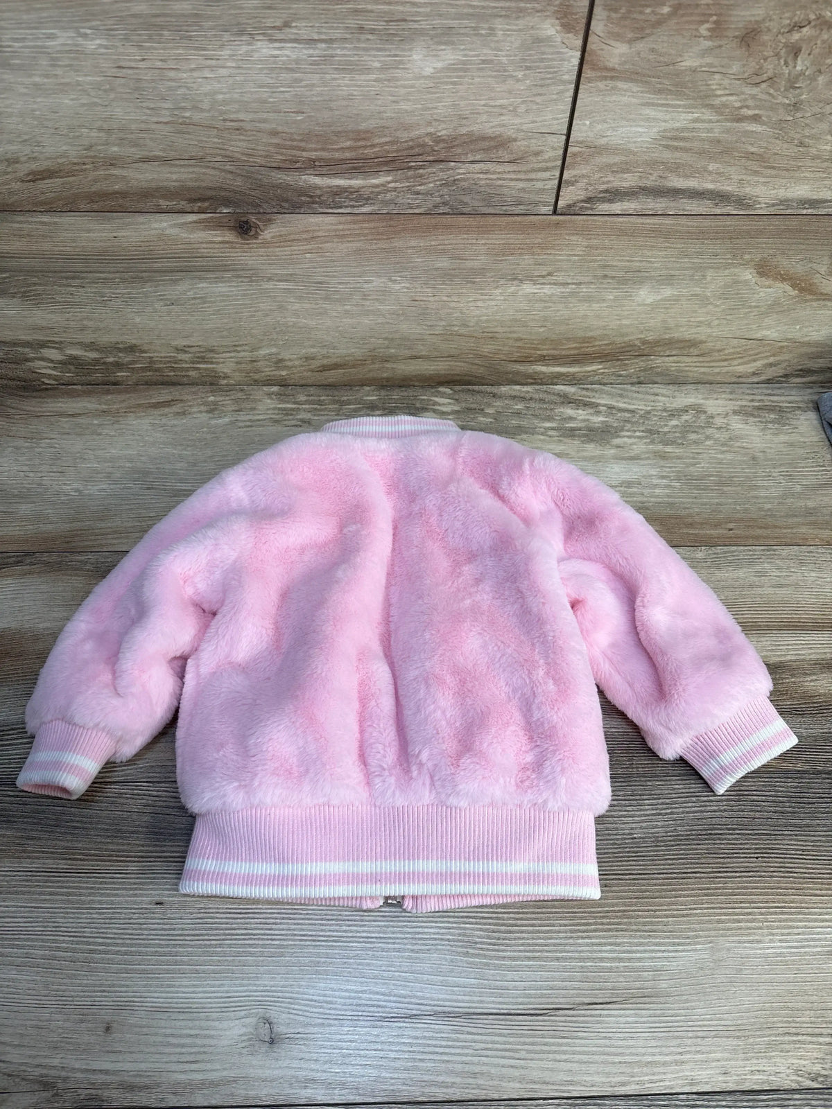 Soft pink faux fur baby jacket with striped cuffs, cozy kids outerwear for chilly days