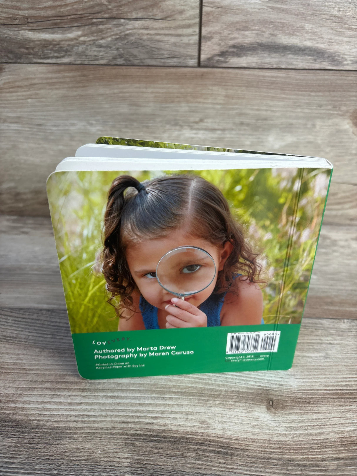 Kids book with girl using magnifying glass, perfect for children's learning and exploration