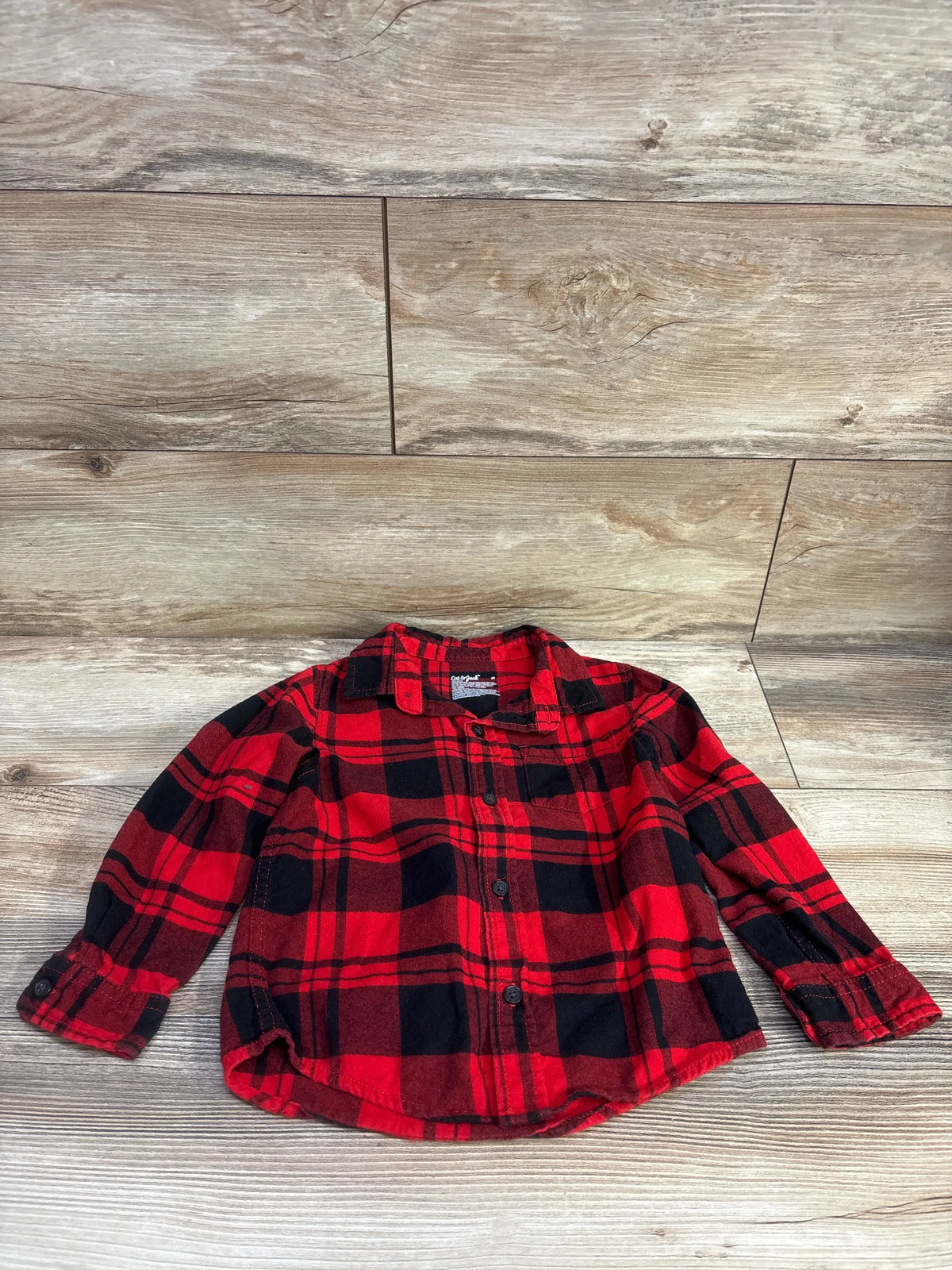 Front view of Cat & Jack toddler red and black plaid flannel shirt size 4T with button front and chest pocket on light wood floor