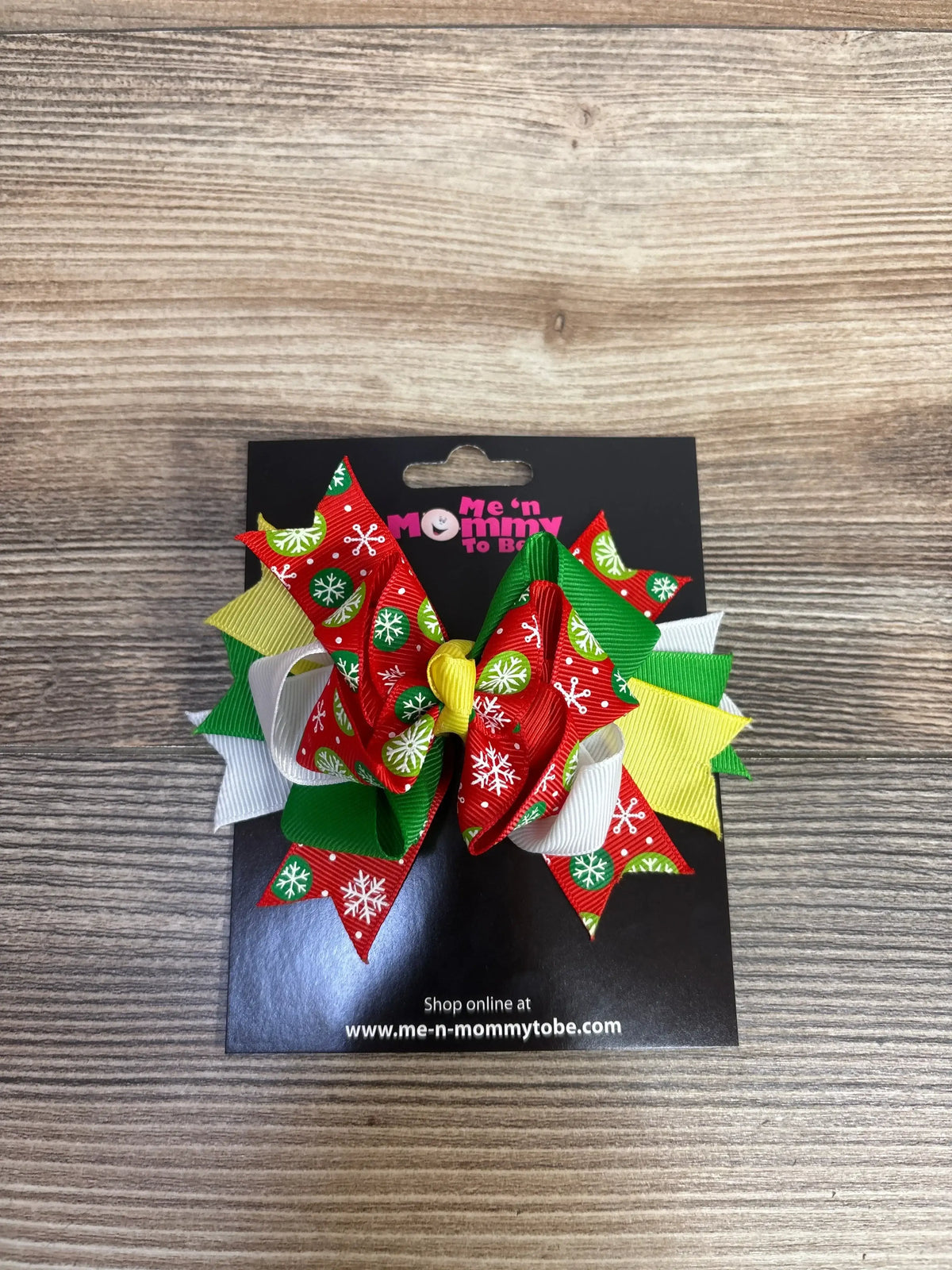 Festive red, green, and white snowflake hair bow for kids, perfect for holiday outfits and Christmas celebrations.