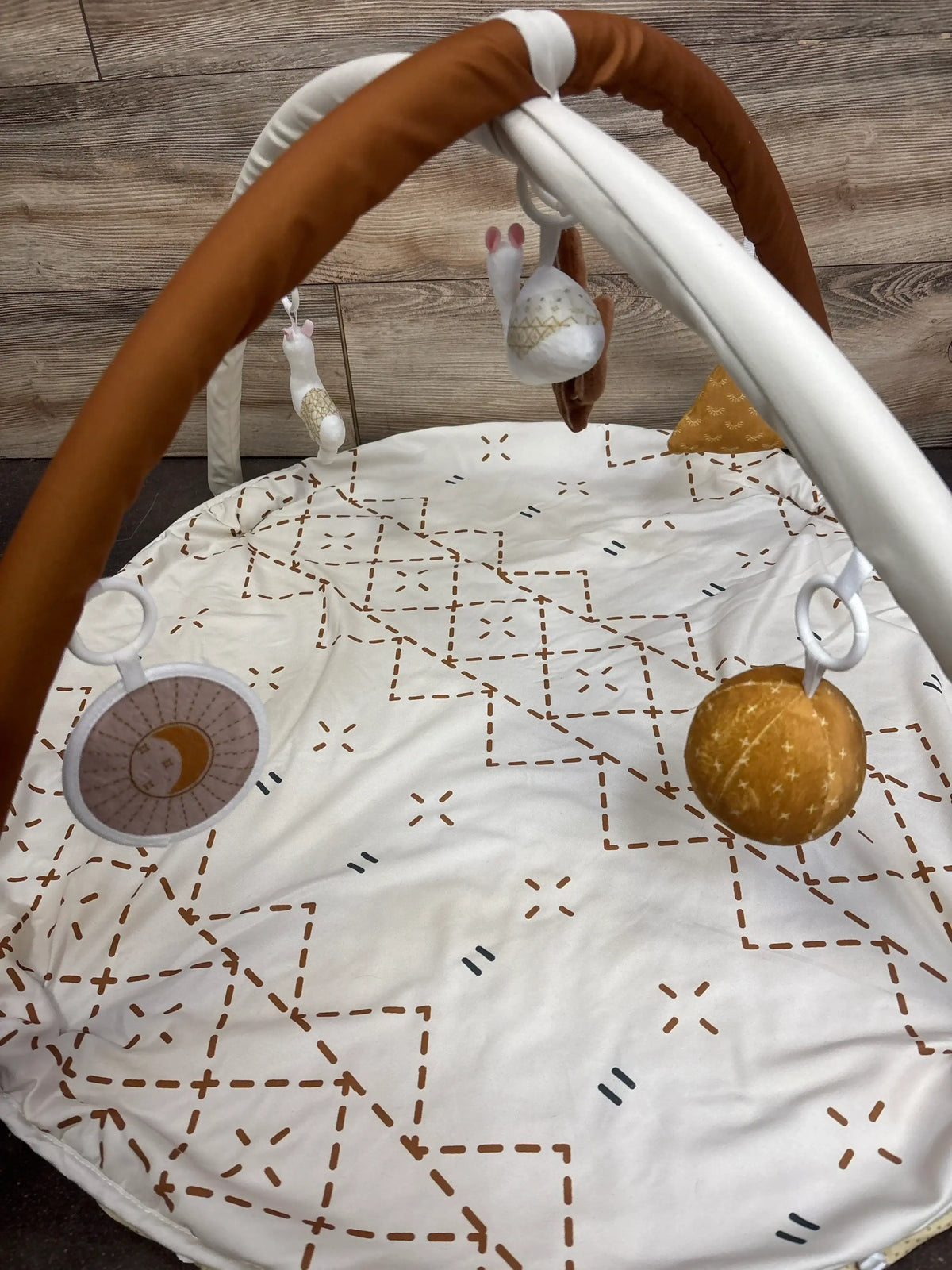 Baby activity gym with star-patterned mat, plush toys, and hanging rattles for newborns and infants