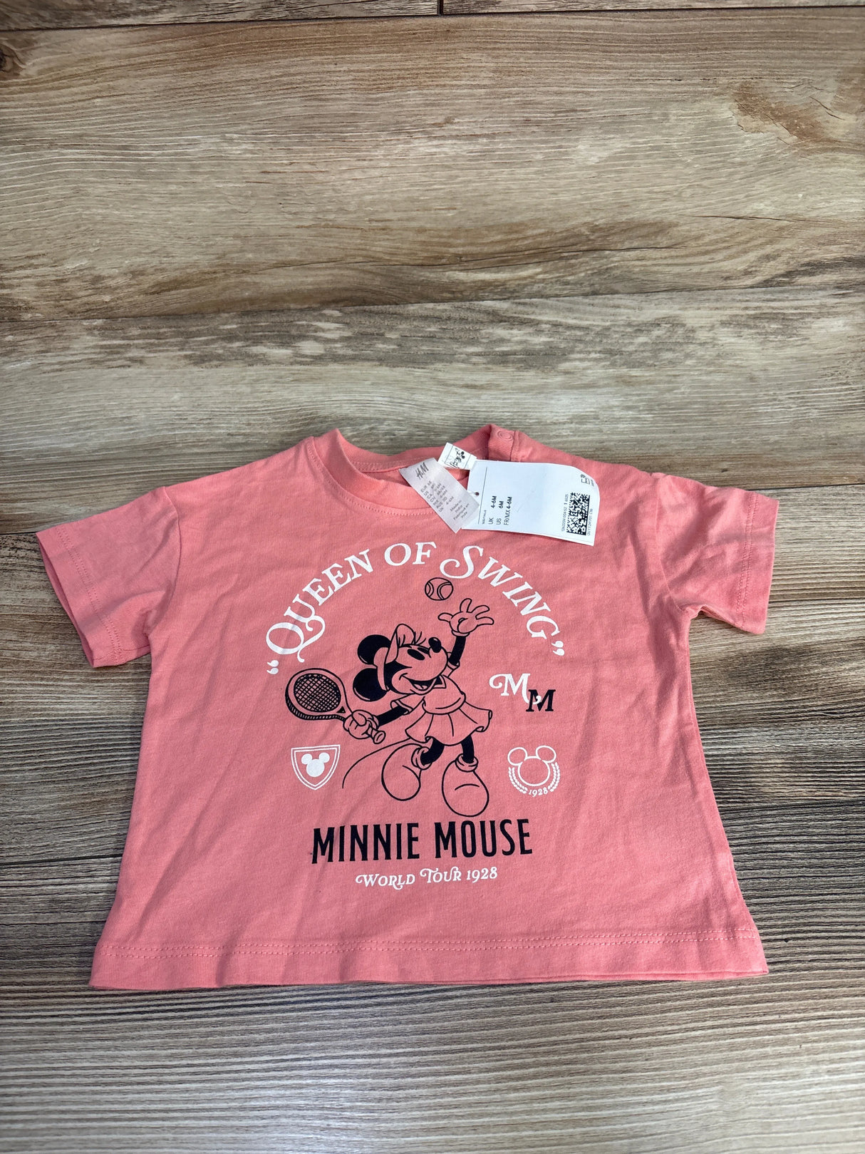 Pink toddler t-shirt with Minnie Mouse tennis design and text Queen of Swing, Minnie Mouse World Tour 1928
