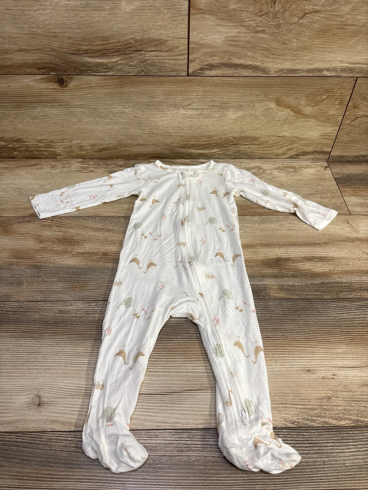 Flat lay of a white Just One You PurelySoft sleeper with long sleeves, full zipper, footed legs, and animal print