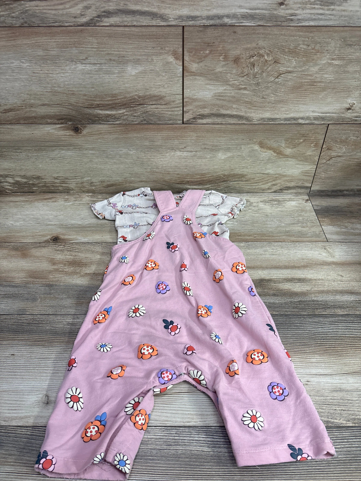 Boxlunch pink floral infant overalls and t-shirt set with Disney Minnie and Daisy patterns.