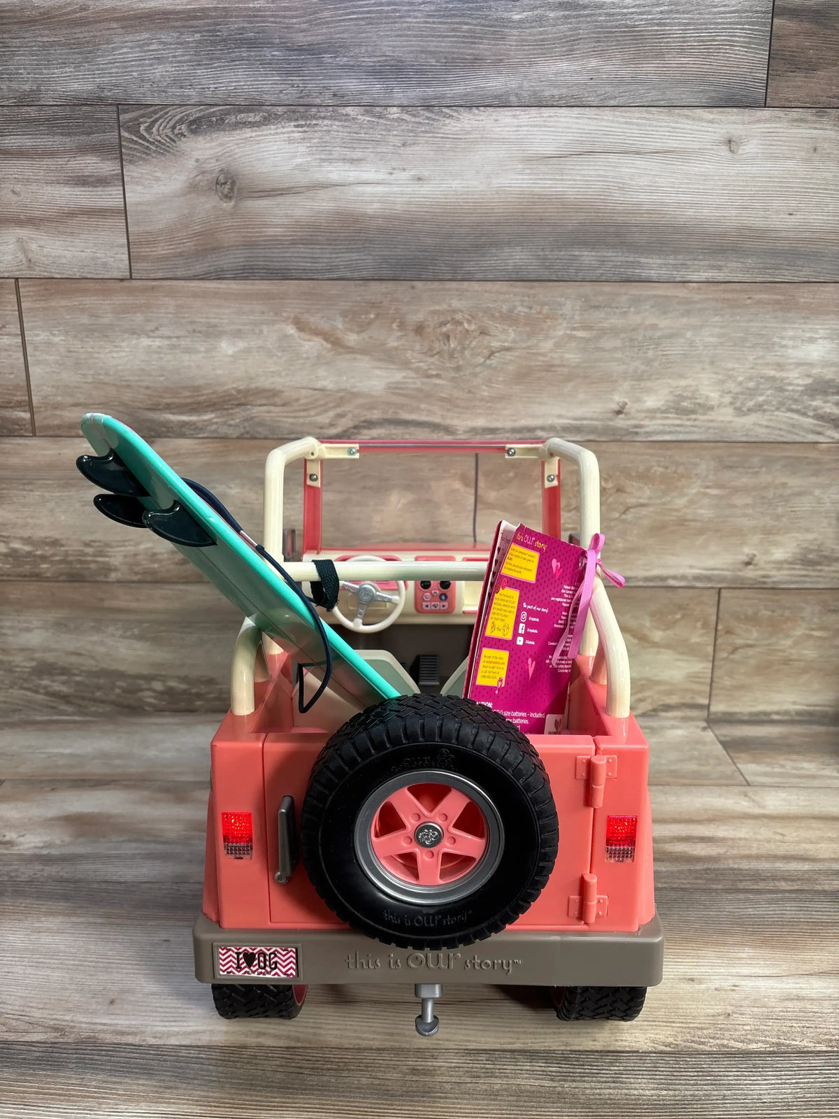 Pink Me n Mommy To Be Our Generation Off-Roader 4x4 doll vehicle with a surfboard.