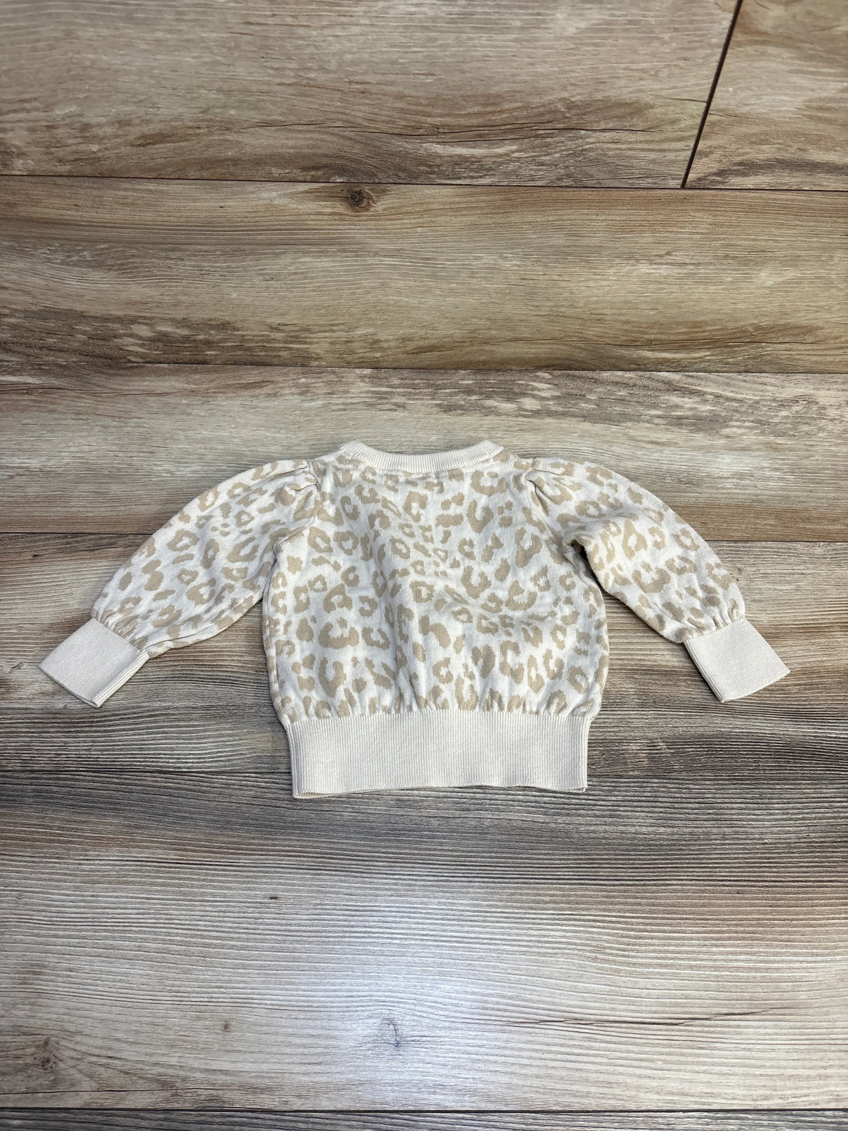 Baby leopard print long sleeve sweater on wood floor, kids clothing resale