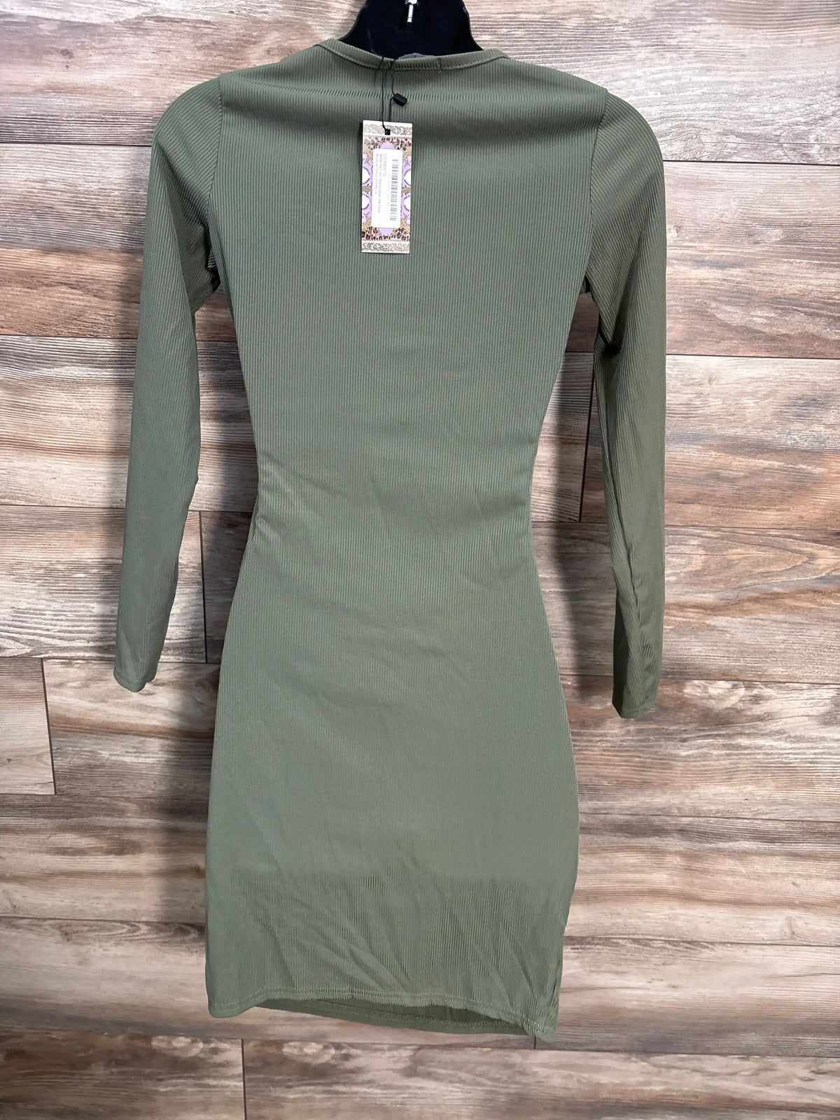 Olive green ribbed long sleeve bodycon dress for women on hanger, wood background