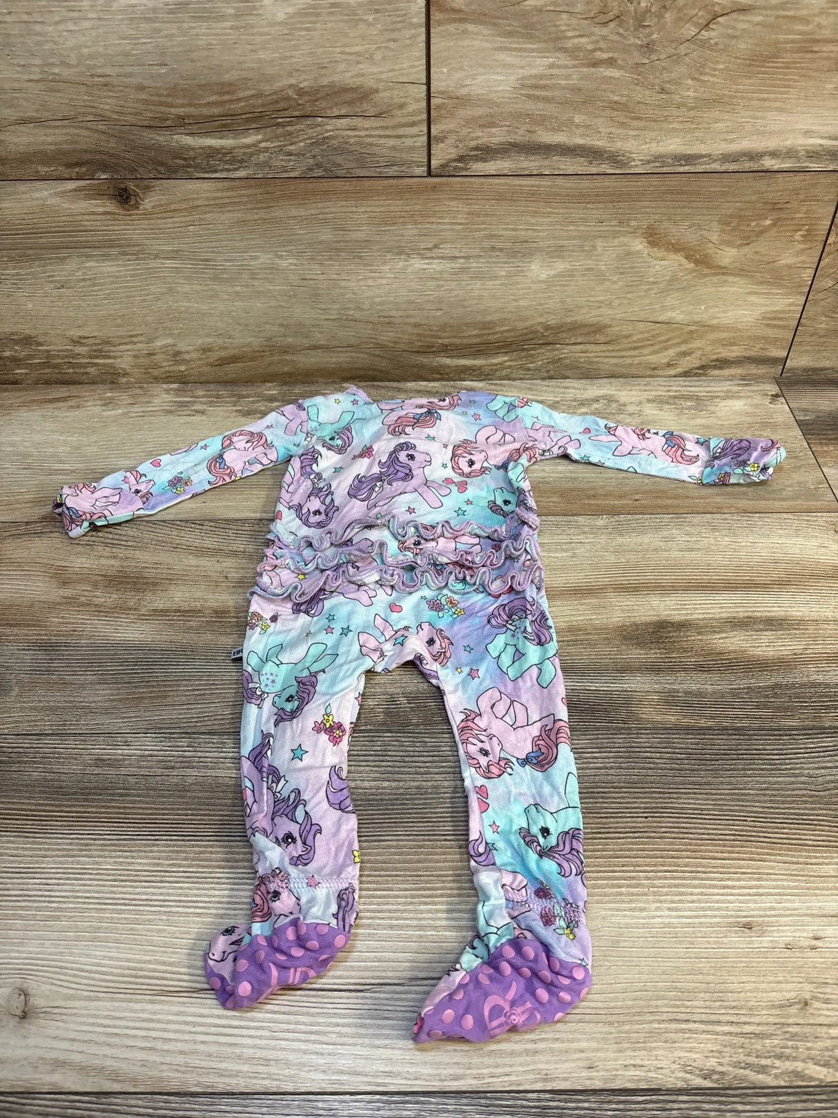 Flat lay lilac My Little Pony footie with ombre clouds, ruffle waist and built in feet with purple nonslip dots