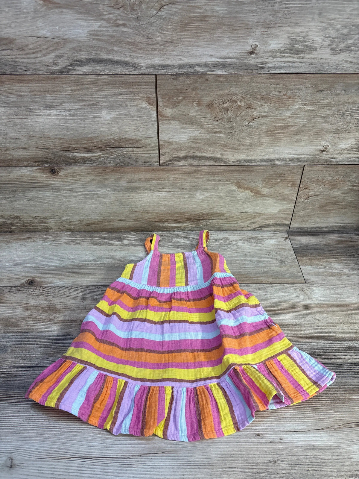 Front view of Cat & Jack 2T striped gauze peplum trim dress showcasing multicolor stripes with wood-look background