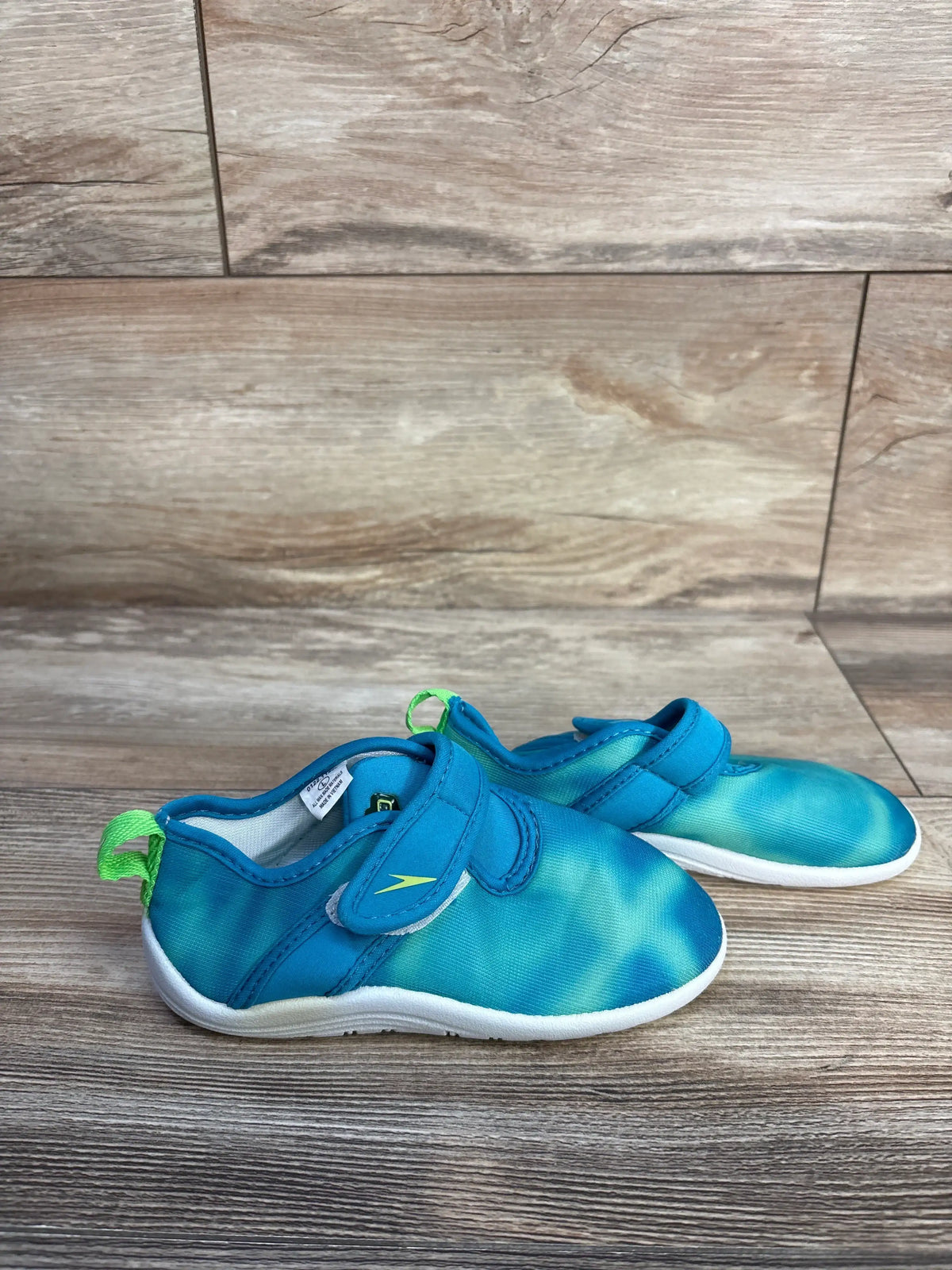 Front and side view of Speedo Shore Explorer Water Shoes in seafoam with mesh uppers and easy-closure straps on wood flooring