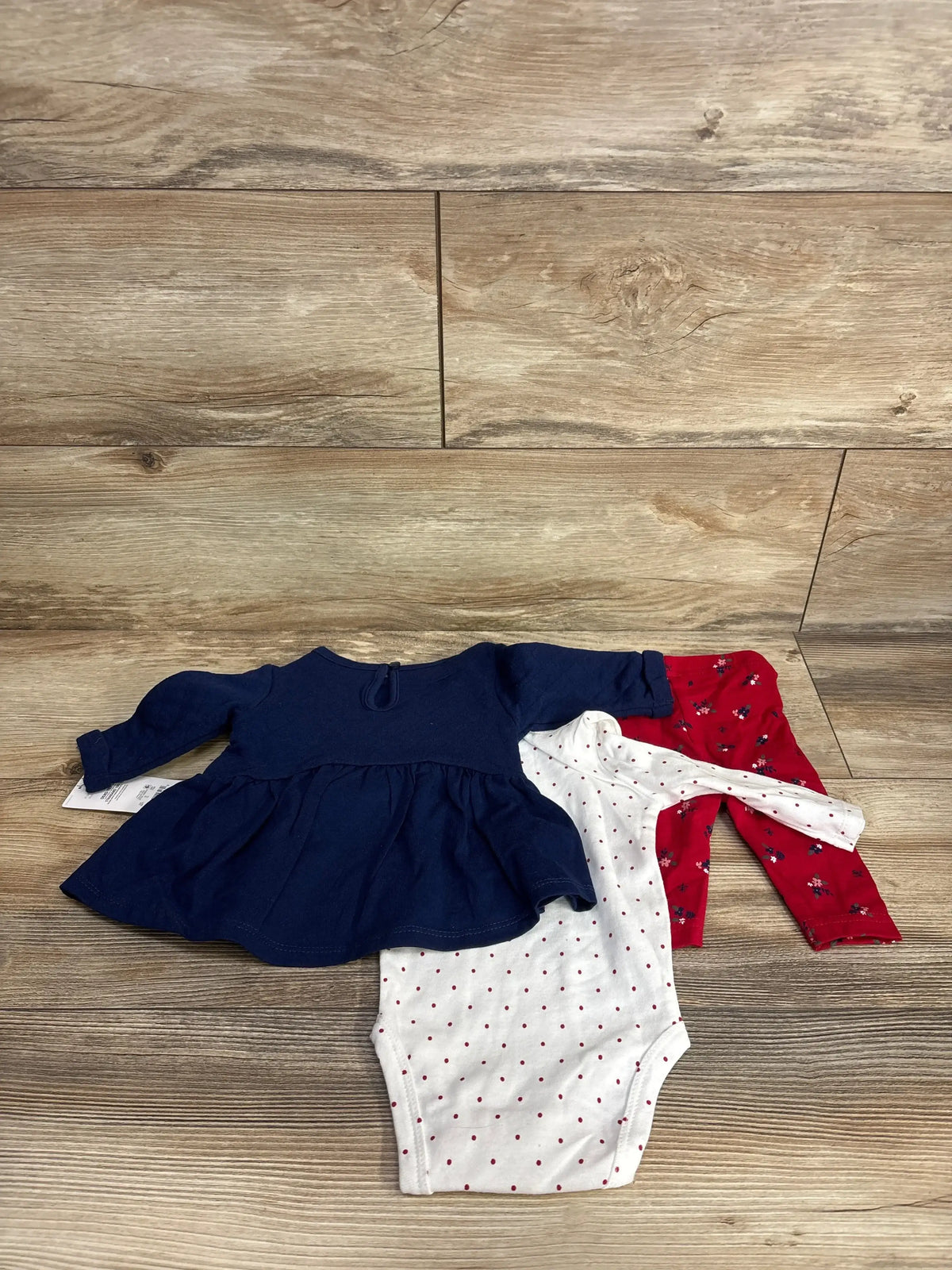 Baby girl outfit set with navy dress, white polka dot bodysuit, and red floral pants