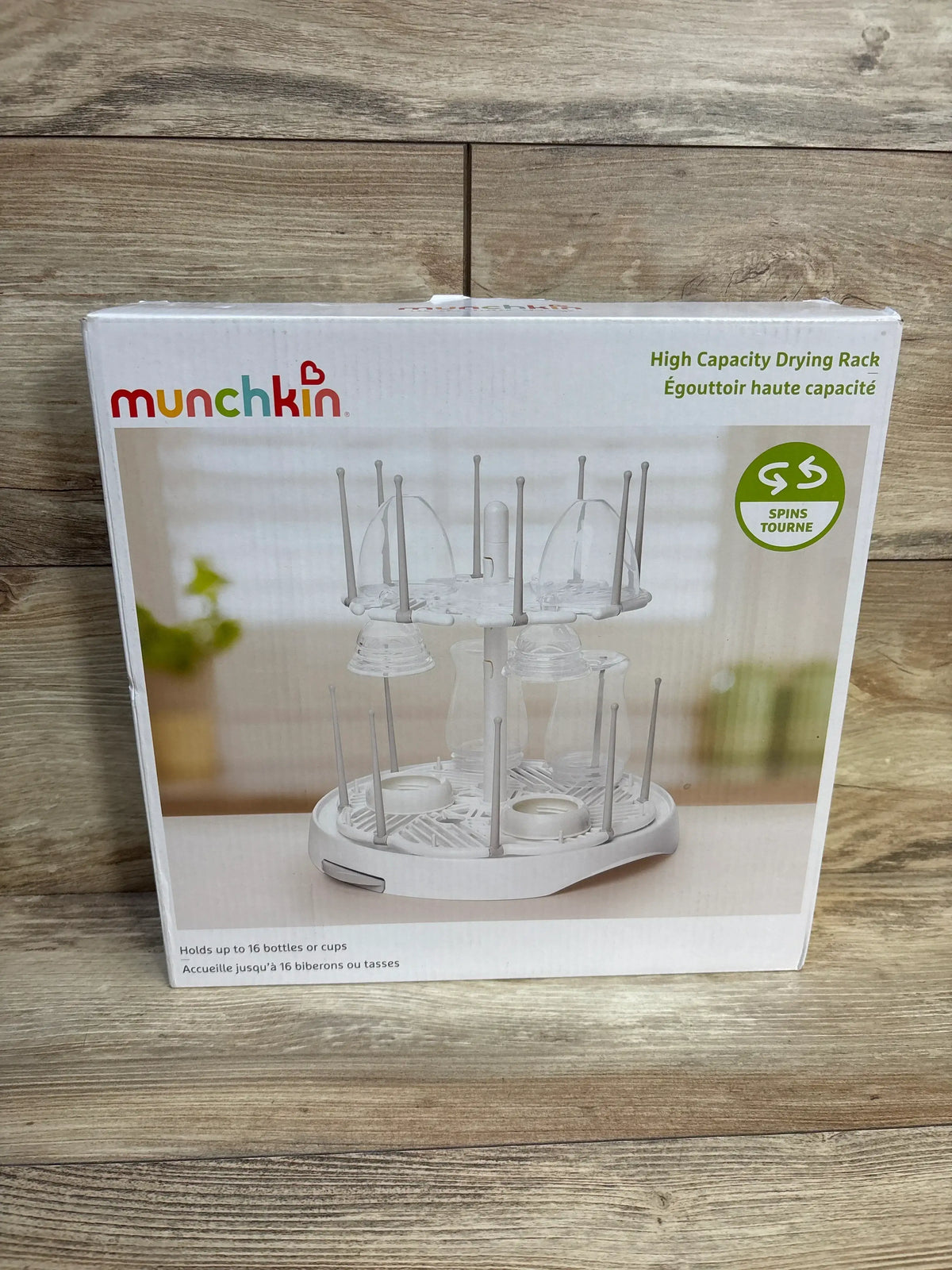 Front view of Munchkin high capacity bottle drying rack box showing two tier spinning pegs and capacity for 16 bottles or cups