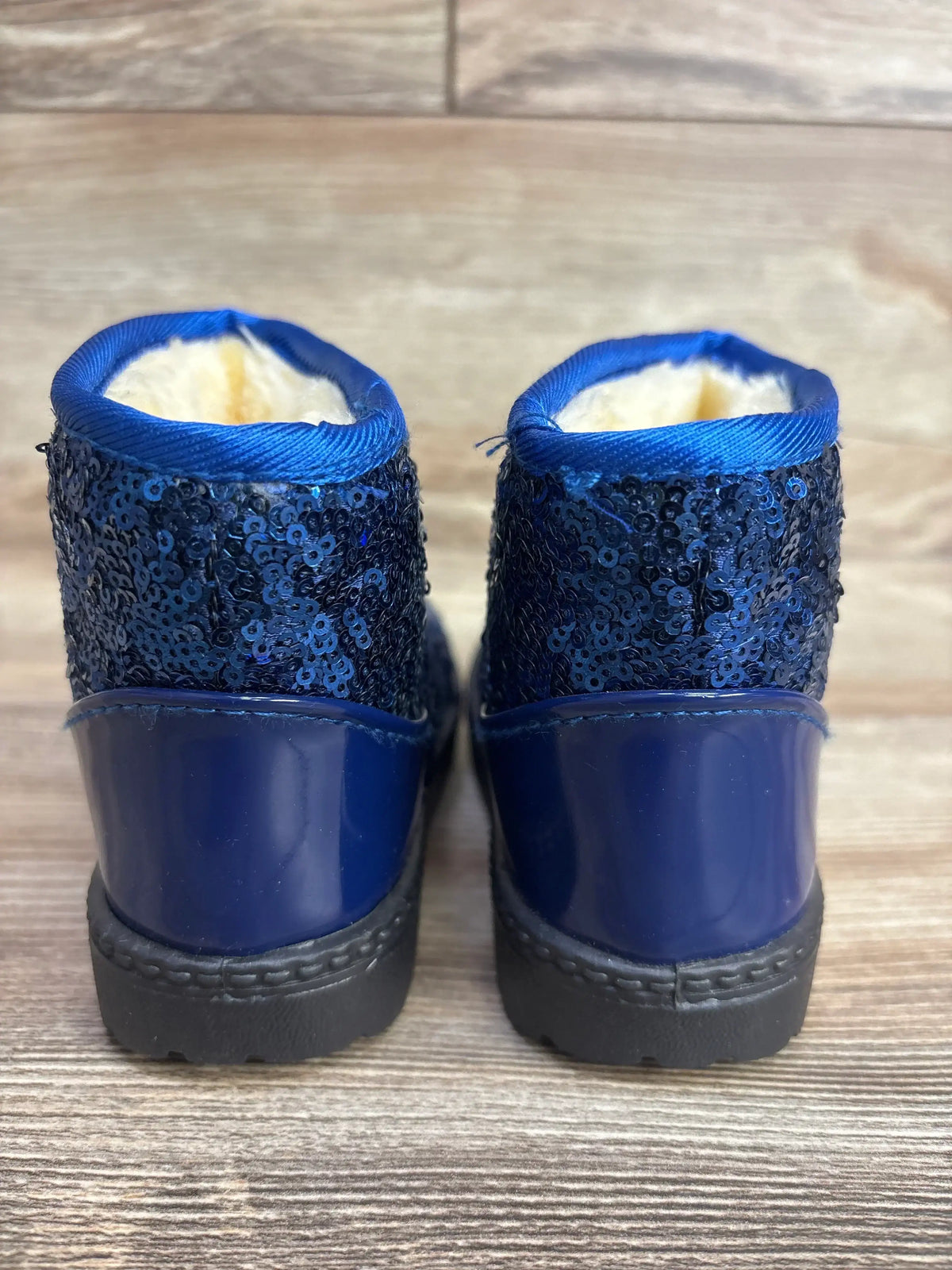 Rear view of sparkly blue toddler boots with sequins, faux fur lining, and rubber soles